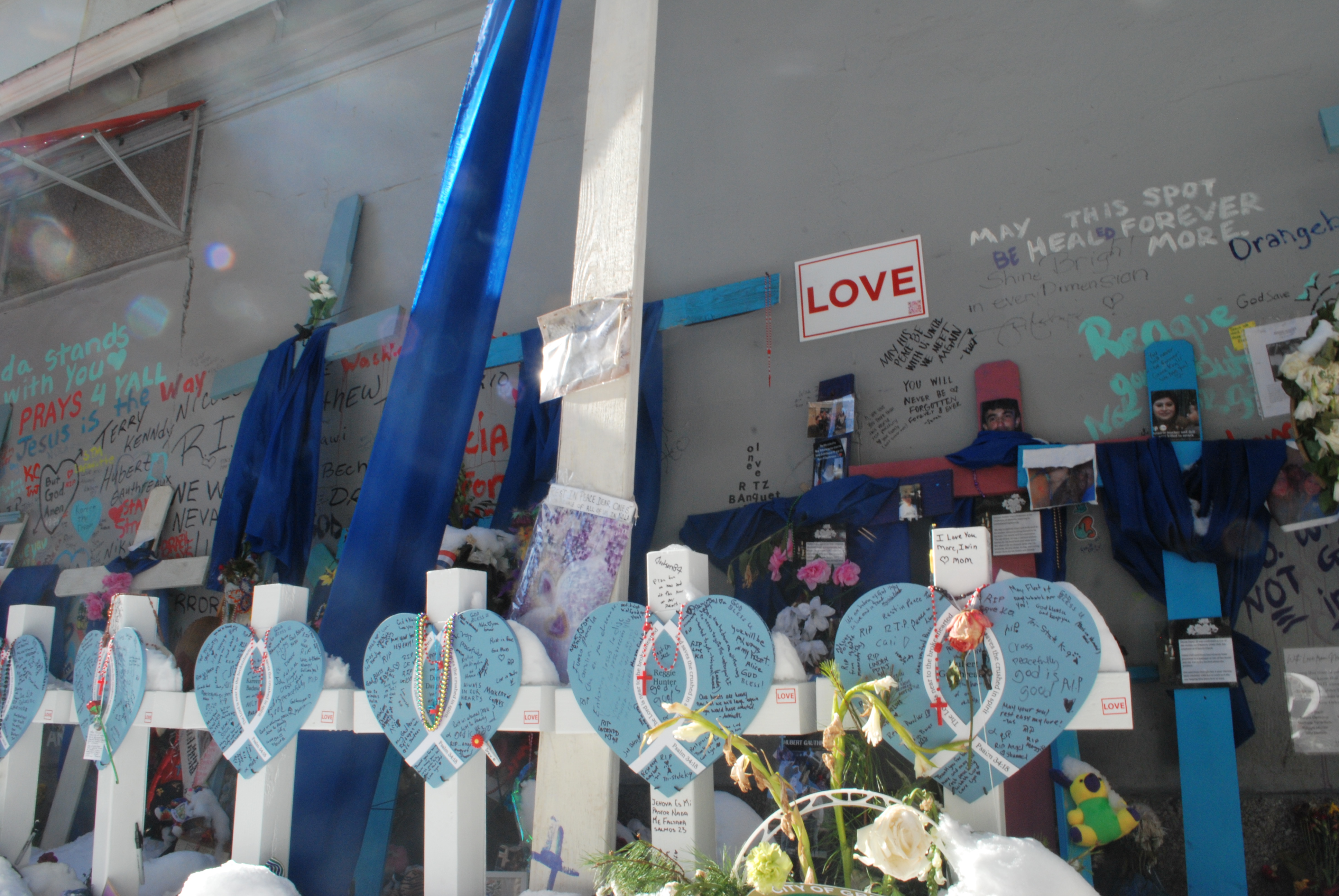 A row of white crosses stand at a makeshift memorial on Bourbon Street