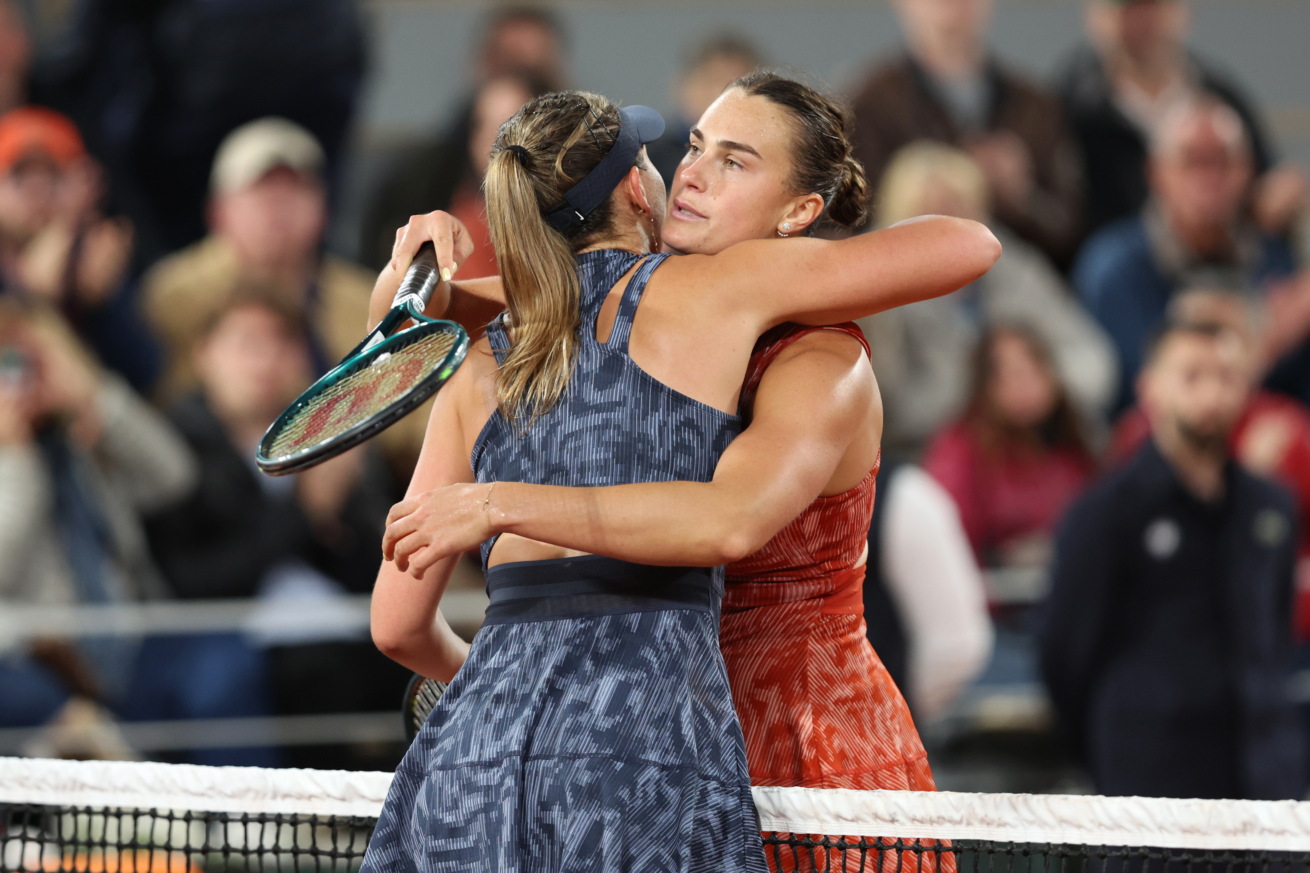 Aryna Sabalenka and Paula Badosa hug.