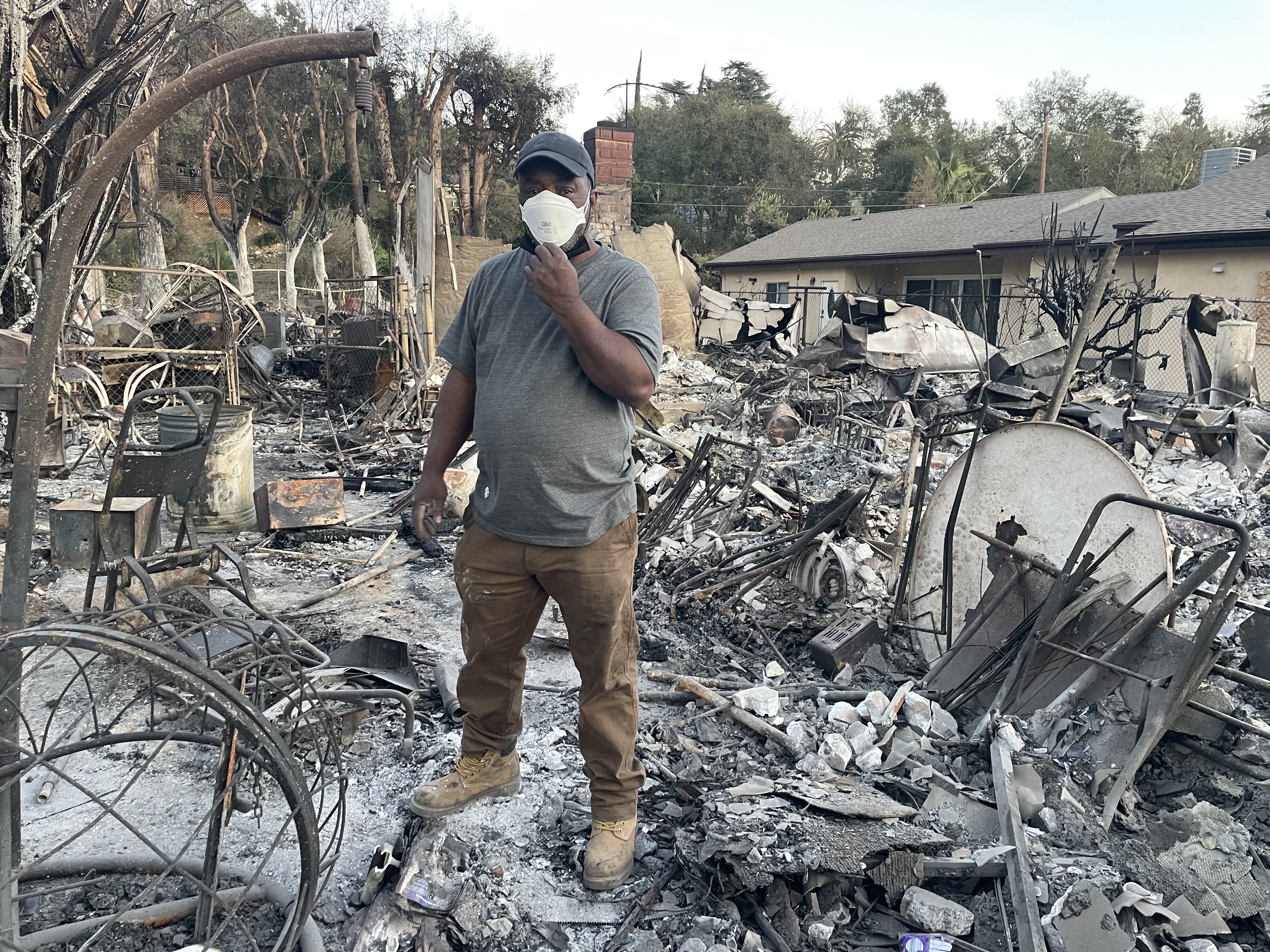 Bill Threadgill, standing in the remains of his house after the 2025 Los Angeles wildfires