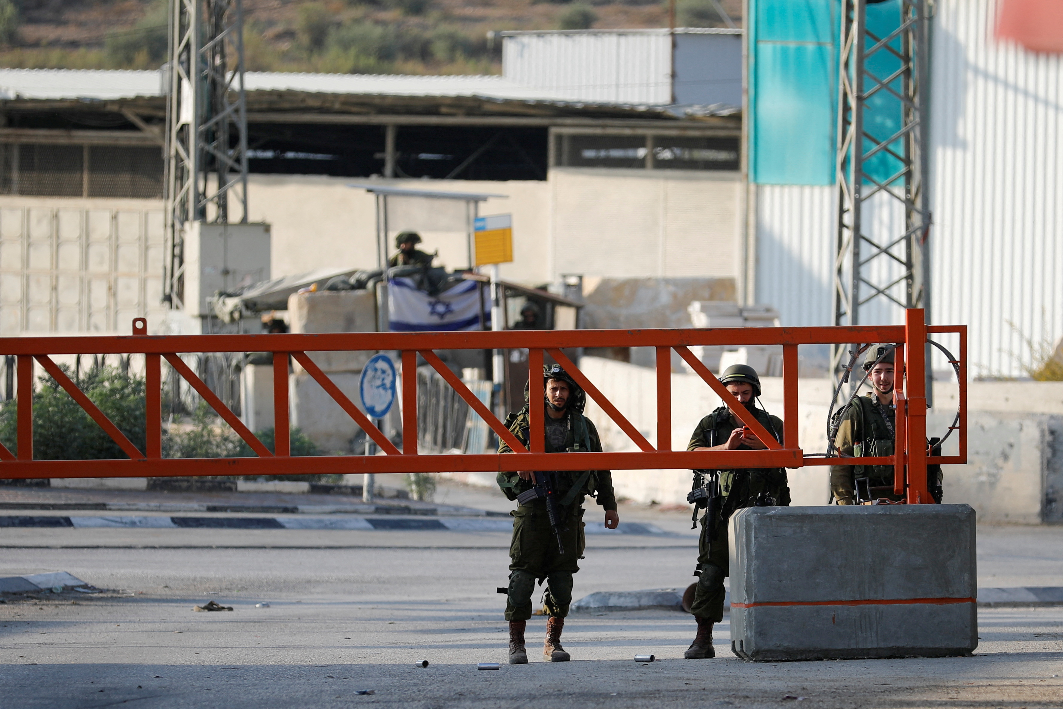 Israeli troops stand guard after settlers' attack in Deir Sharaf, near Nablus in the Israeli-occupied West Bank November 2, 2023. REUTERS/Raneen Sawafta