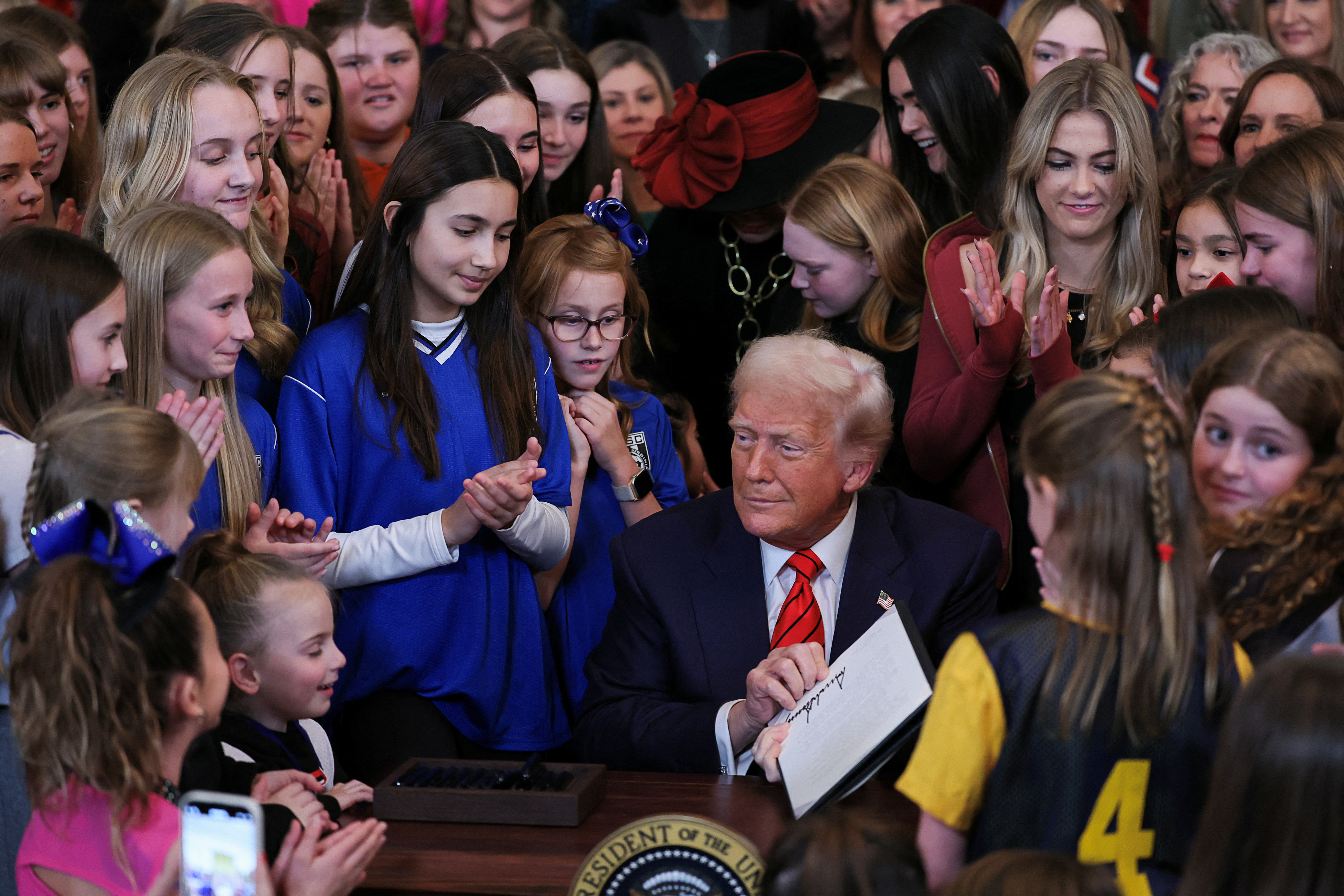 U.S. President Donald Trump holds a signed executive order banning transgender girls and women from participating in women's sports, in the East Room at the White House in Washington, U.S., February 5, 2025. REUTERS/Leah Millis