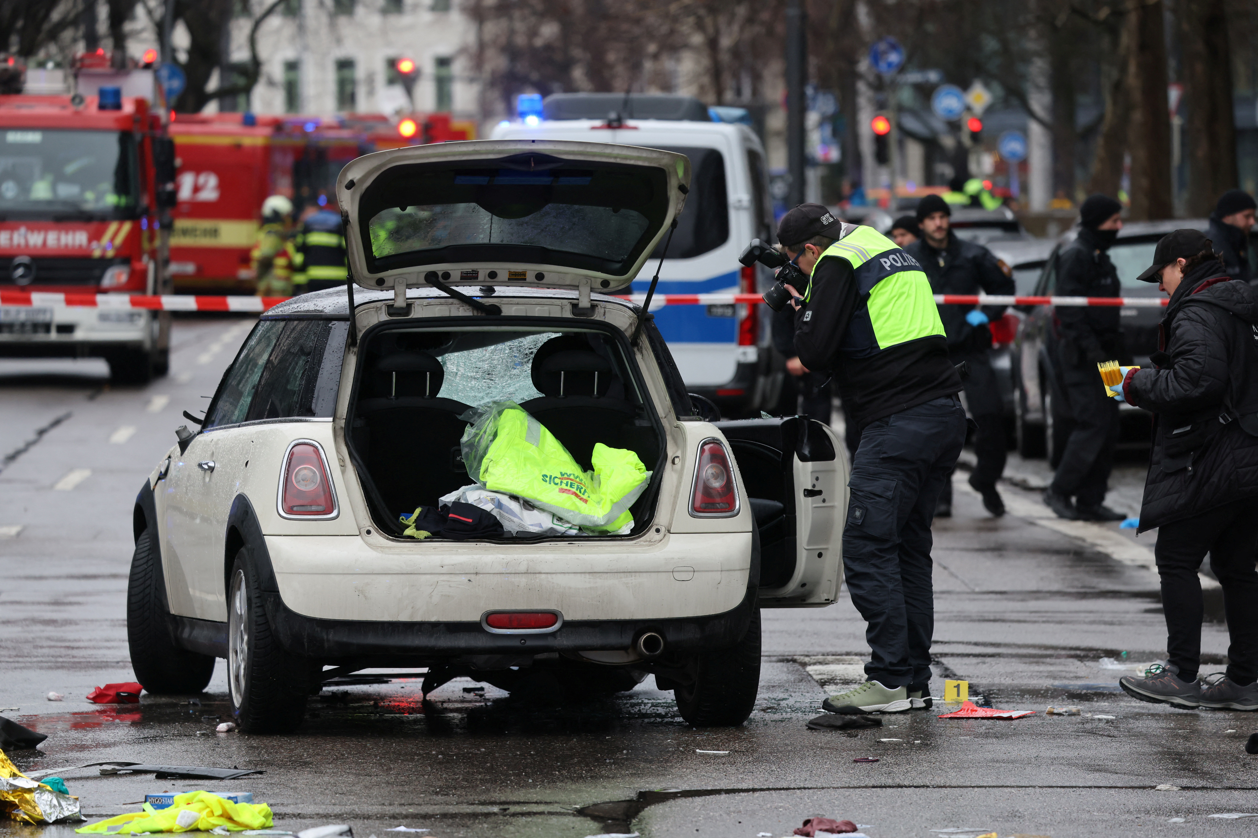Police takes pictures of a car which drove into a crowd.