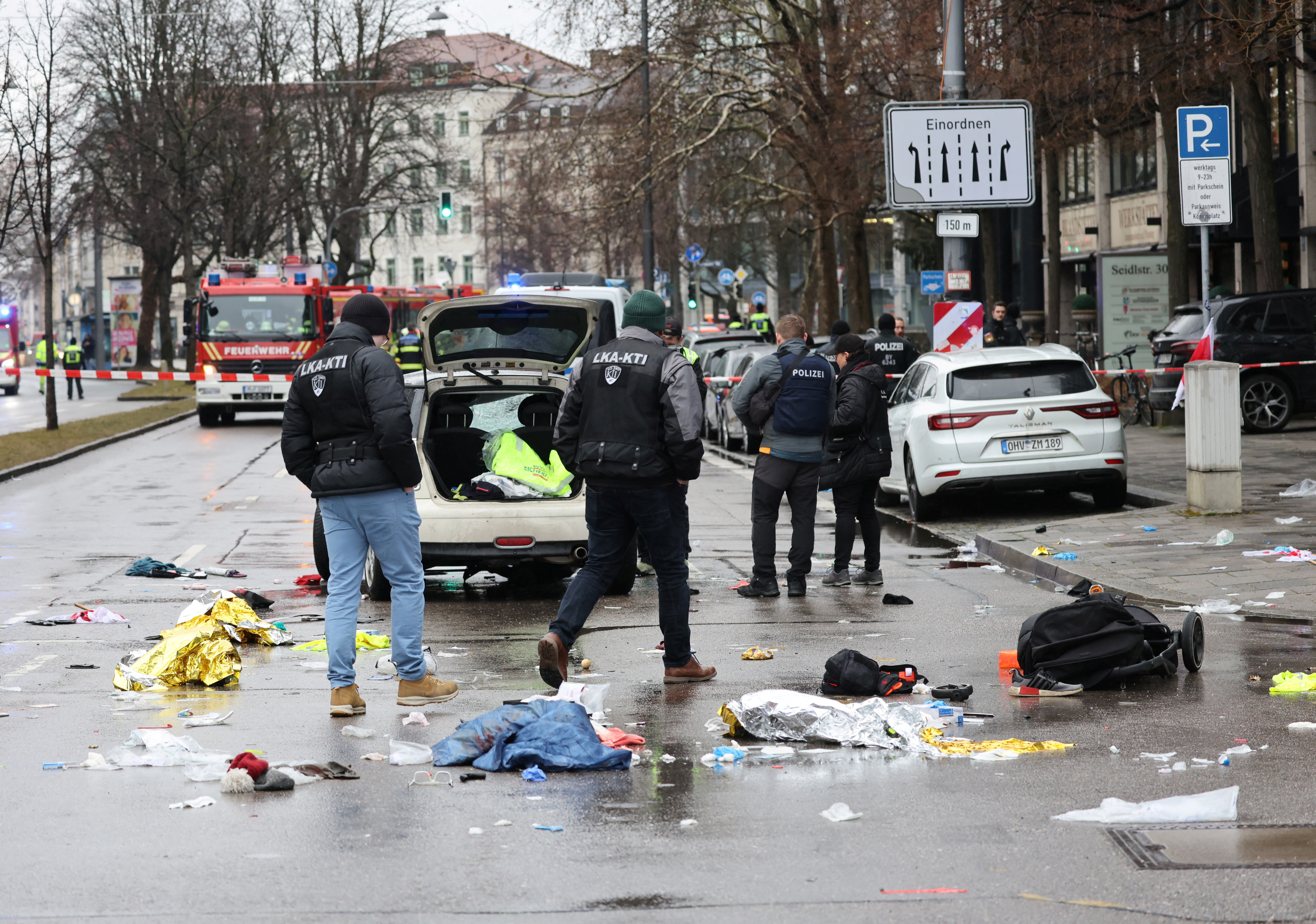 Police walks past a car which drove into a crowd in Munich, Germany