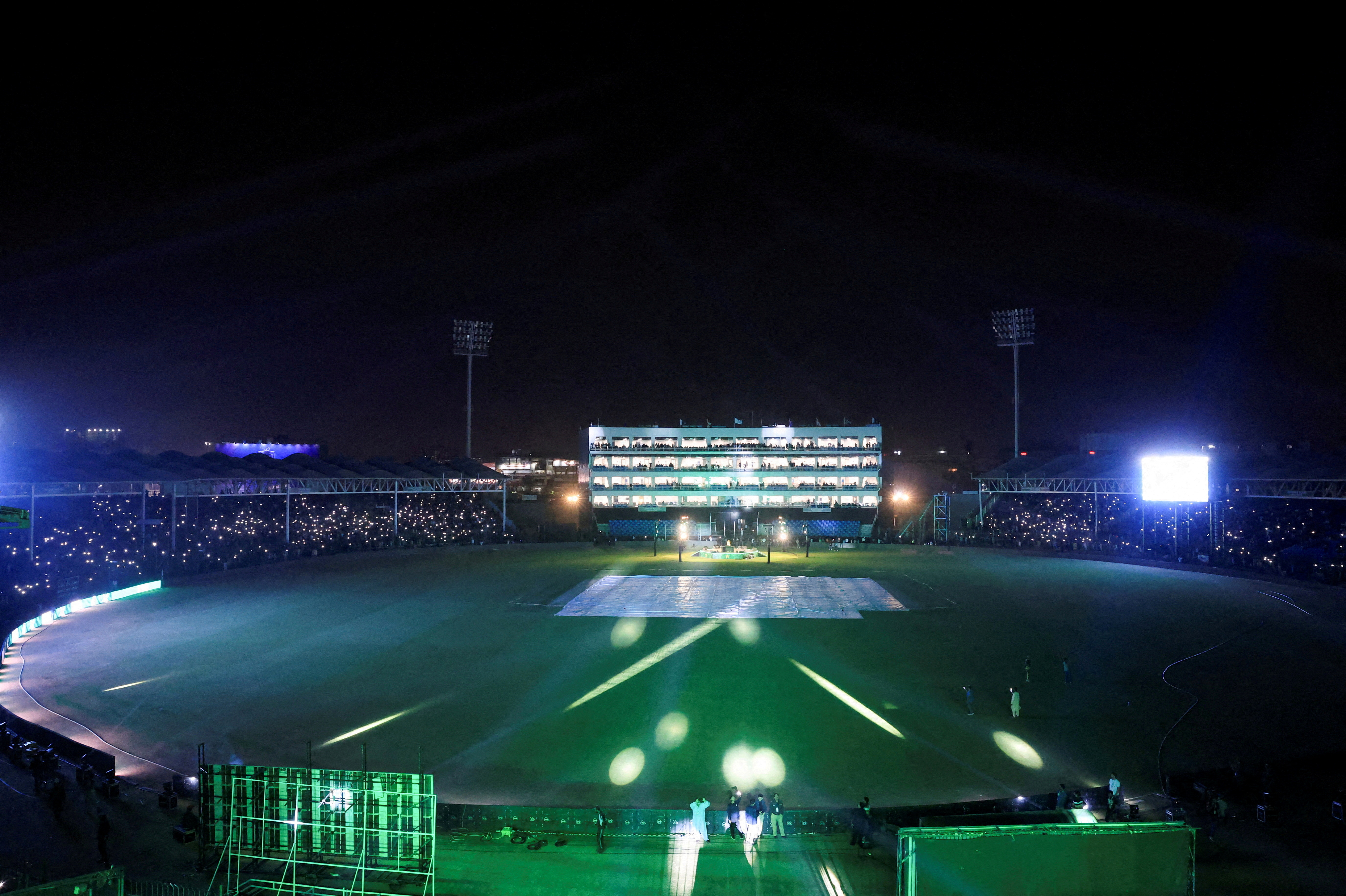 FILE PHOTO: People flash lights from their mobile phones during the inauguration of the National Bank Stadium after the completion of renovation works ahead of the ICC Champions Trophy 2025 tournament in Karachi, Pakistan February 11, 2025. REUTERS/Akhtar Soomro/File Photo