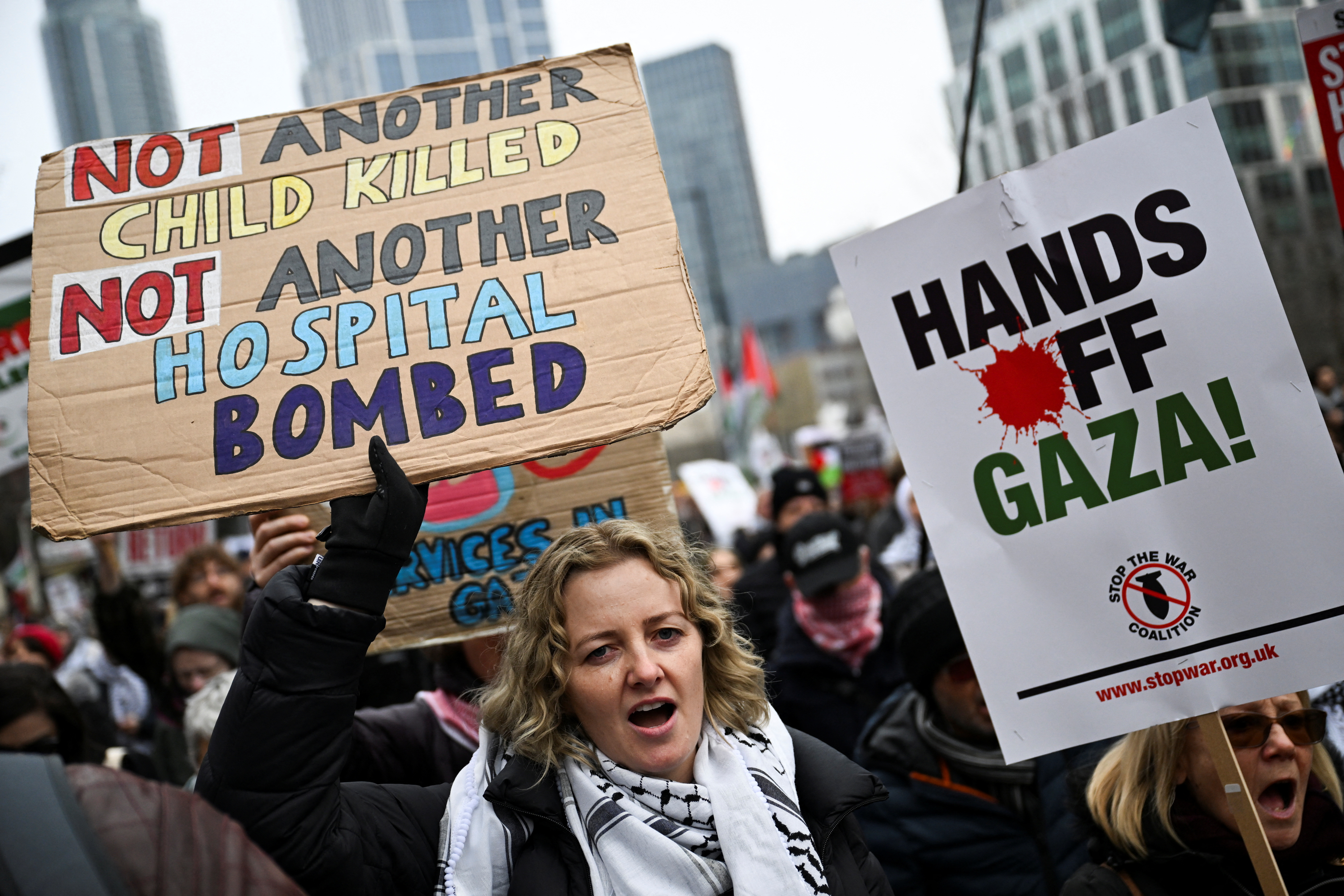 A Pro-Palestinian demonstrator carries placards during a march in opposition to U.S President Donald Trump's plan to displace Palestinians from Gaza and "take over" the territory, in London, Britain February 15, 2025. [File: Chris J. Ratcliffe/Reuters]