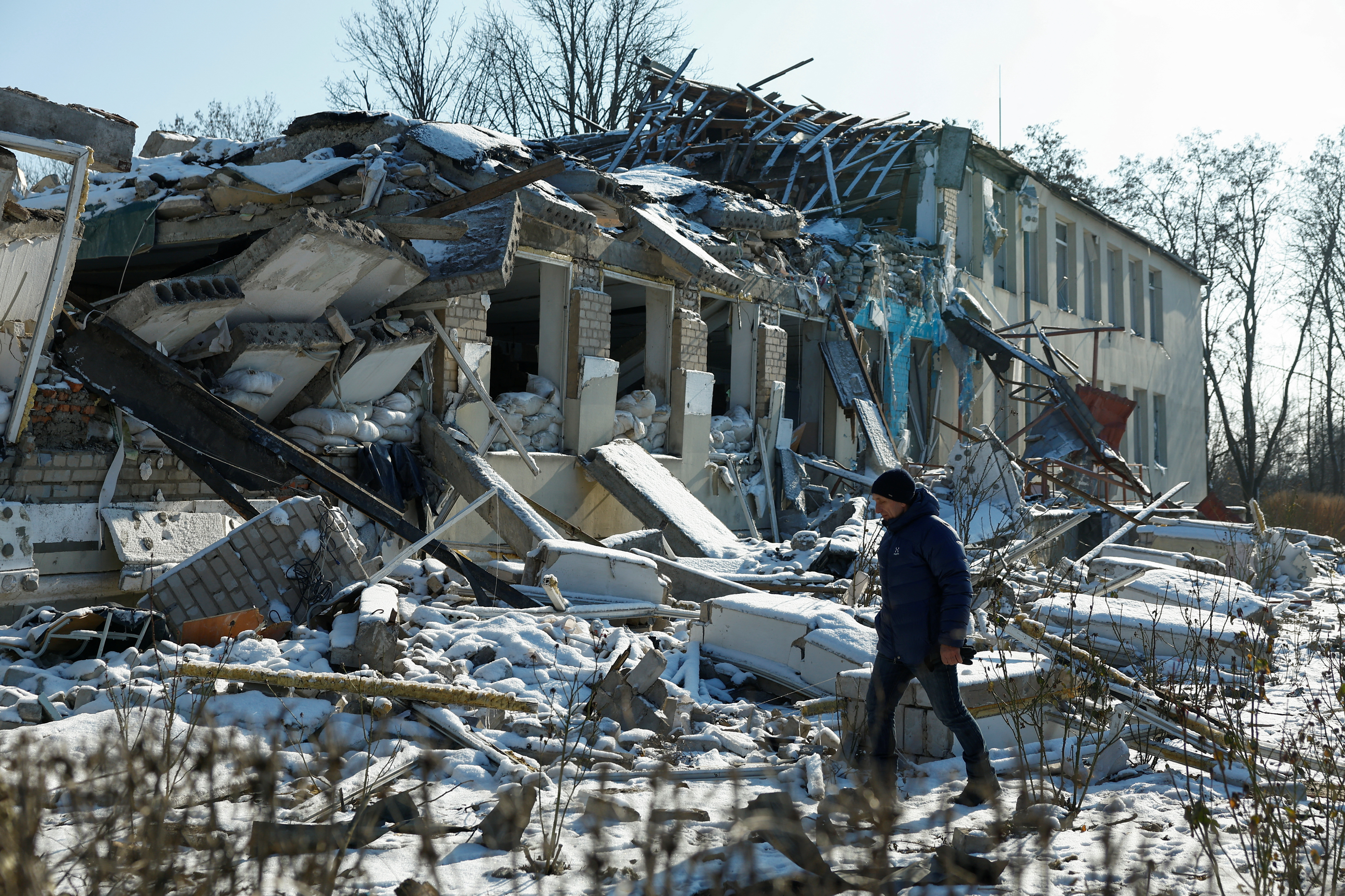 A man stands next to destruction in the village of Novopavlivka in Ukraine's Dnipropetrovsk region