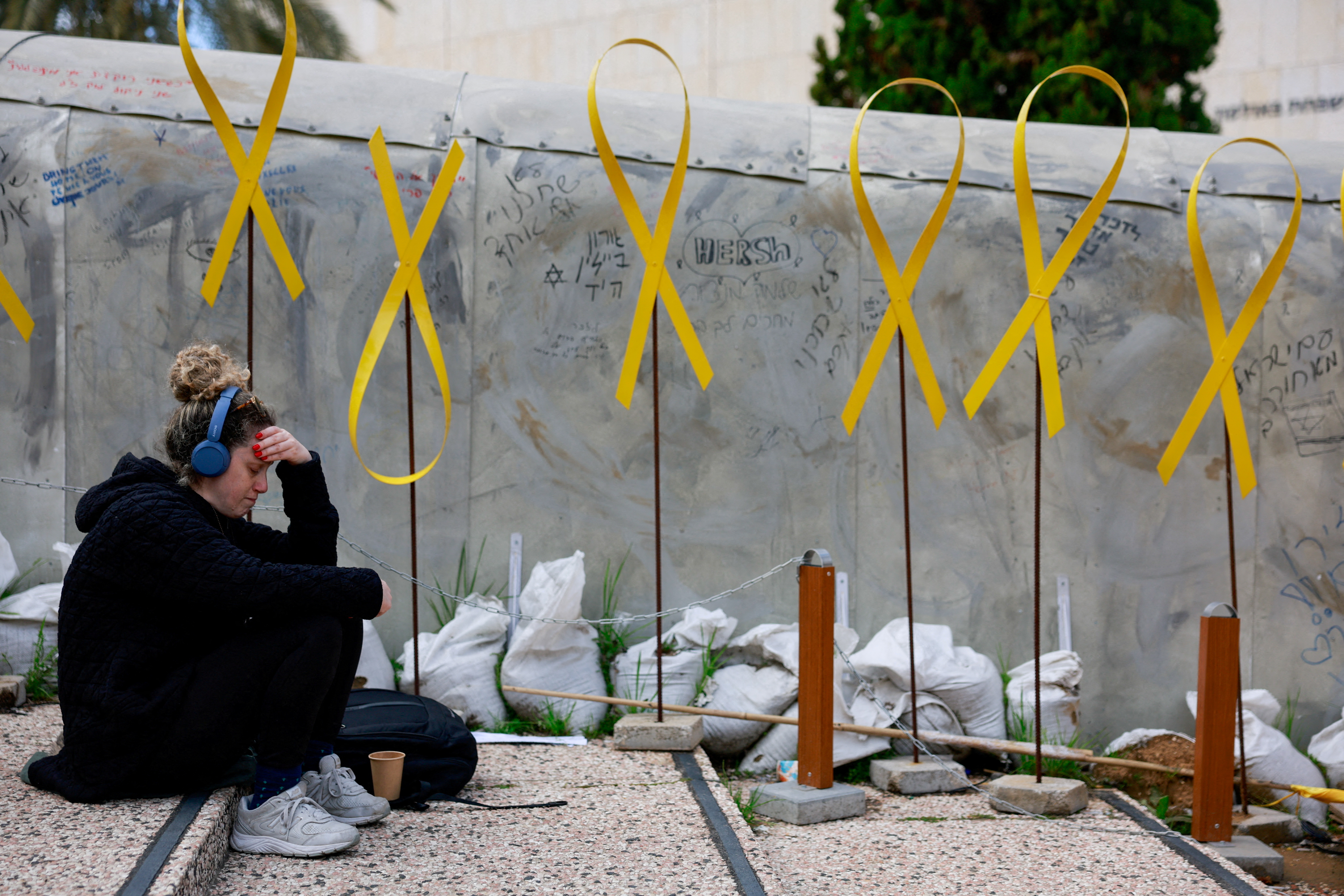 A person sits near a memorial for Israeli captives