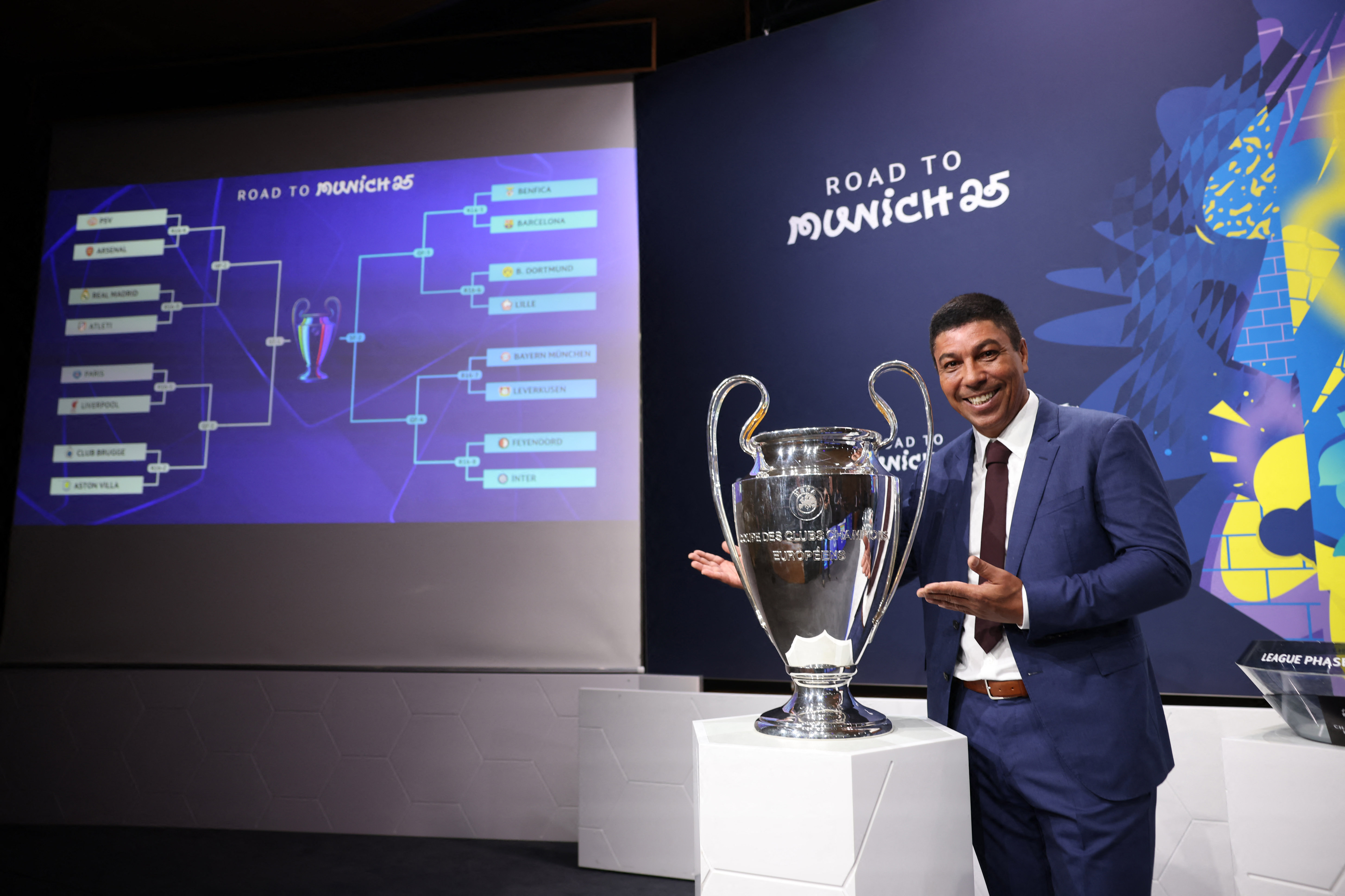 Former Brazil footballer Giovane Elber poses with the Champions League trophy.