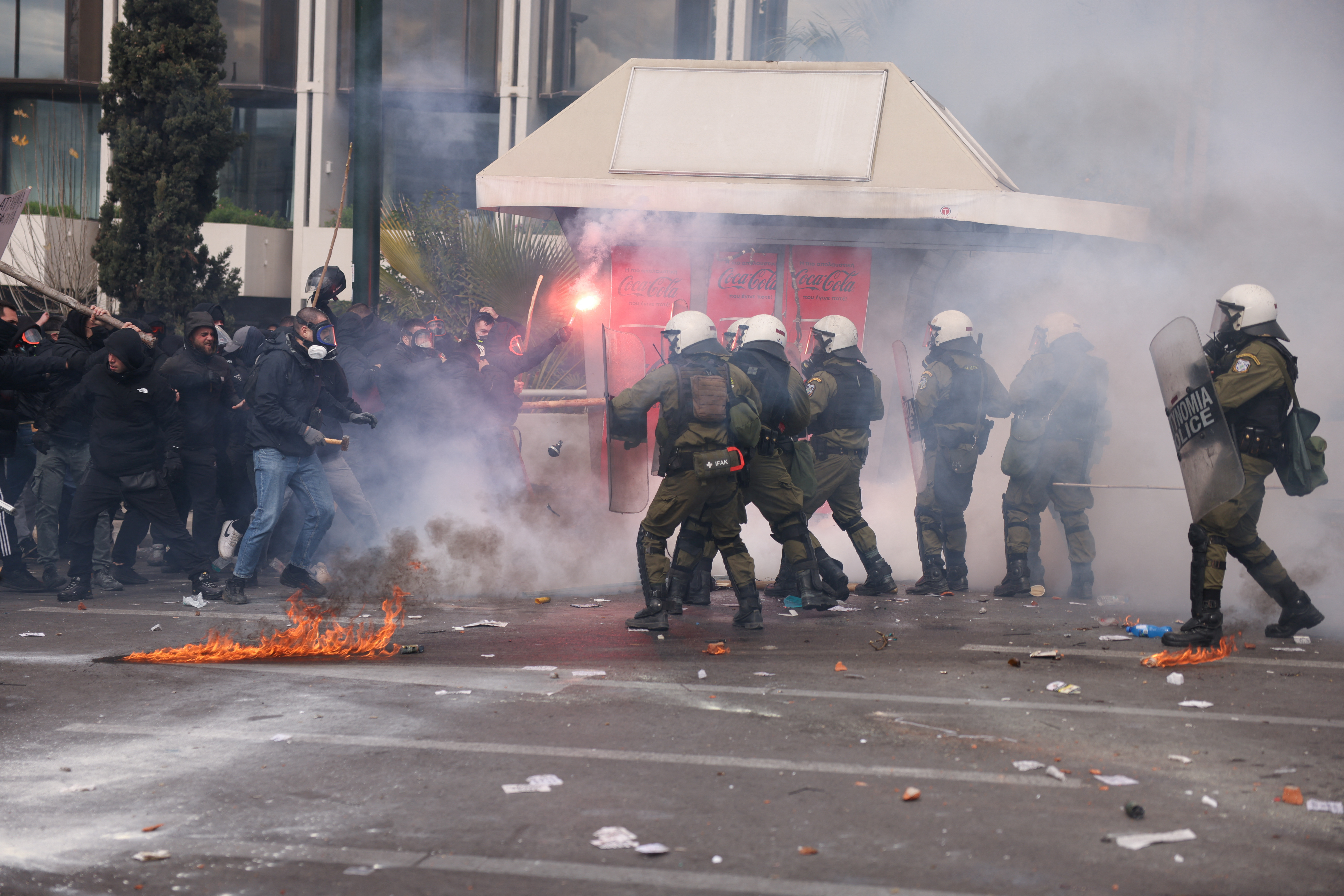 Riot police throw a stun grenade amid clashes with demonstrators, near Greek parliament, during a protest marking the second anniversary of the country's worst railway disaster, while an investigation continues, in Athens, Greece, February 28, 2025. REUTERS/Stelios Misinas