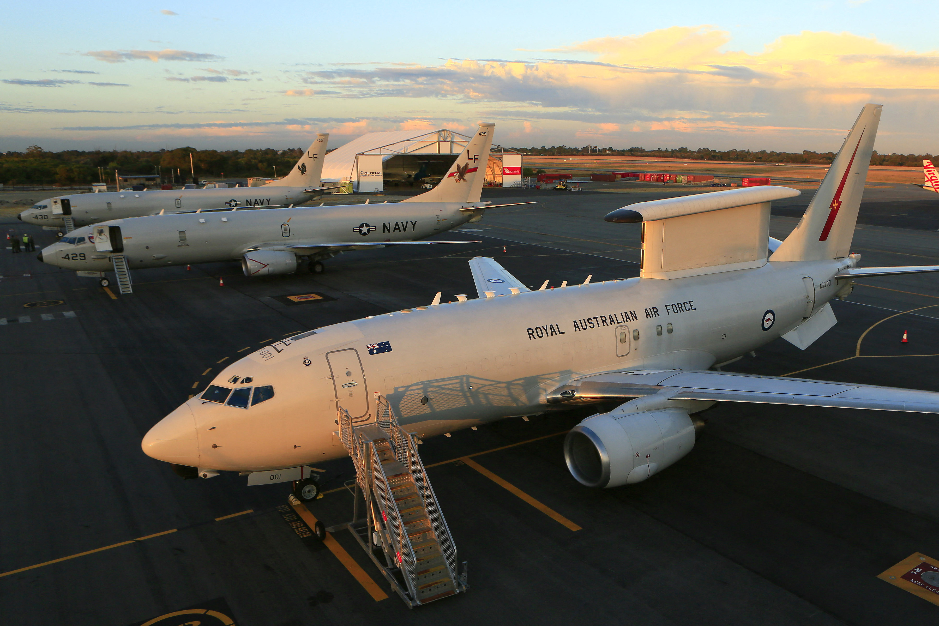 A Royal Australian Air Force E-7A Wedgetail (R) and two US Navy P-8A Poseidon maritime patrol aircraft on the tarmac at Perth international airport.