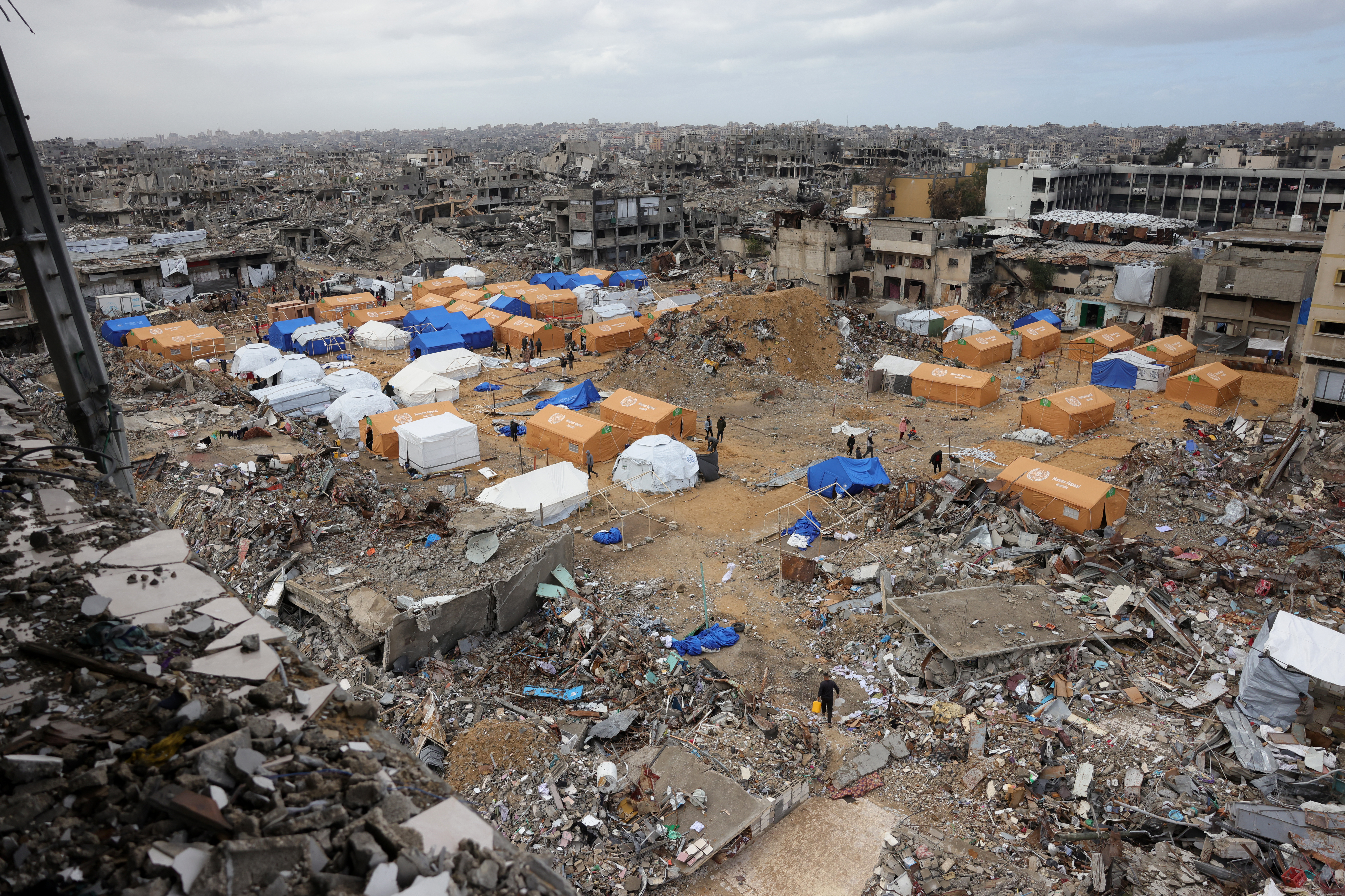 Palestinians take shelter in tents set up amid heavily damaged buildings in Jabalia in the northern Gaza Strip