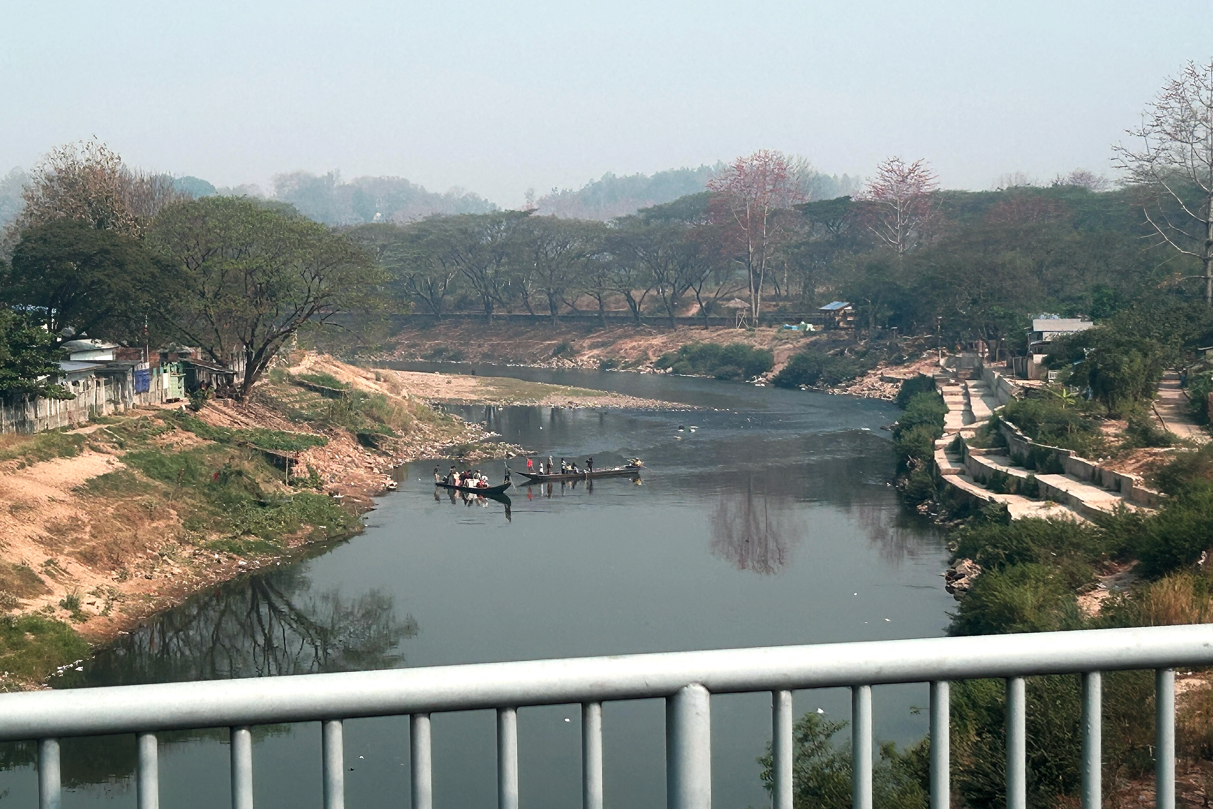 People cross the Moei river flowing between Thailand and Myanmar, as seen from the Thailand-Myanmar Friendship bridge in Thailand's Mae Sot district on February 17, 2025. (Photo by AFP)