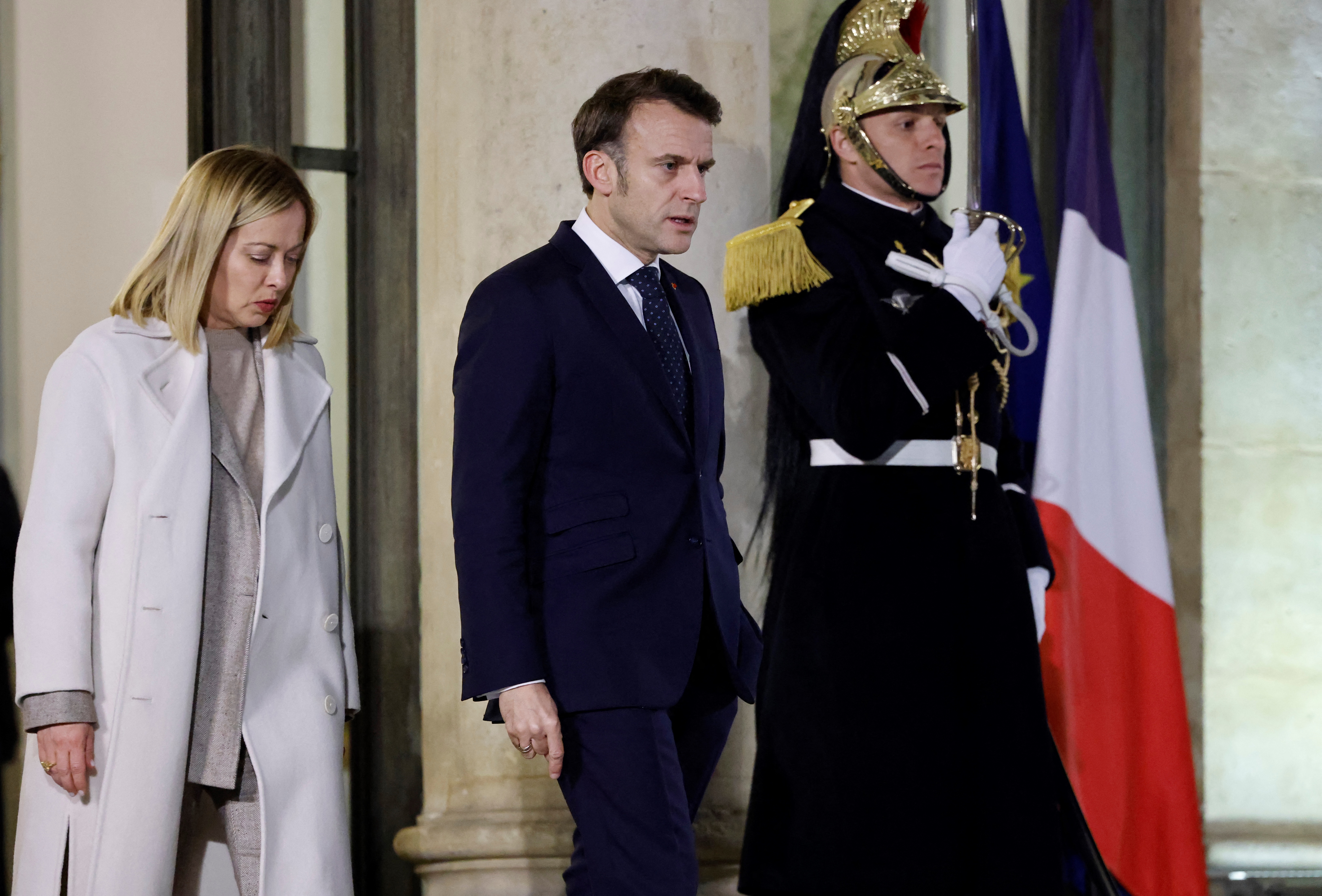 French President Emmanuel Macron (C) walks with Italy's Prime Minister Giorgia Meloni (L) after an informal summit of European leaders to discuss the situation in Ukraine and European security at the Elysee Palace in Paris on February 17, 2025. European leaders were due to meet in Paris on February 17, 2025 to address Washington's shock policy shift on the war in Ukraine, as Britain declared itself ready to dispatch peacekeeping troops to Ukraine. (Photo by Ludovic MARIN / AFP)