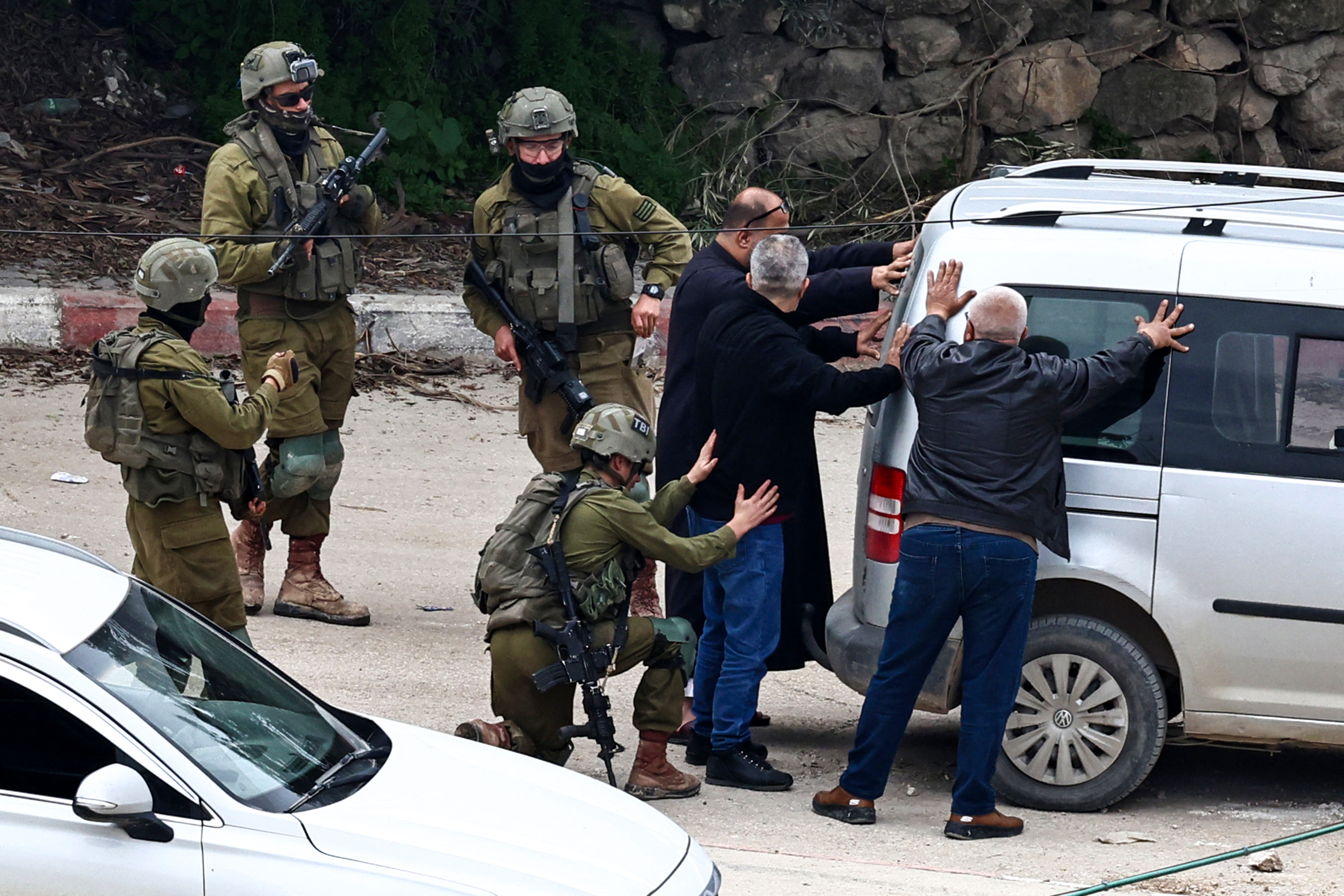 Israeli detain men during an ongoing Israeli raid in the Tulkarem camp for Palestinian refugees in the occupied West Bank on February 19, 2025. Since January 21, the Israeli military has been conducting a major operation in the "triangle" of Jenin, Tubas and Tulkarem, where half a million Palestinians live. (Photo by Zain JAAFAR / AFP)