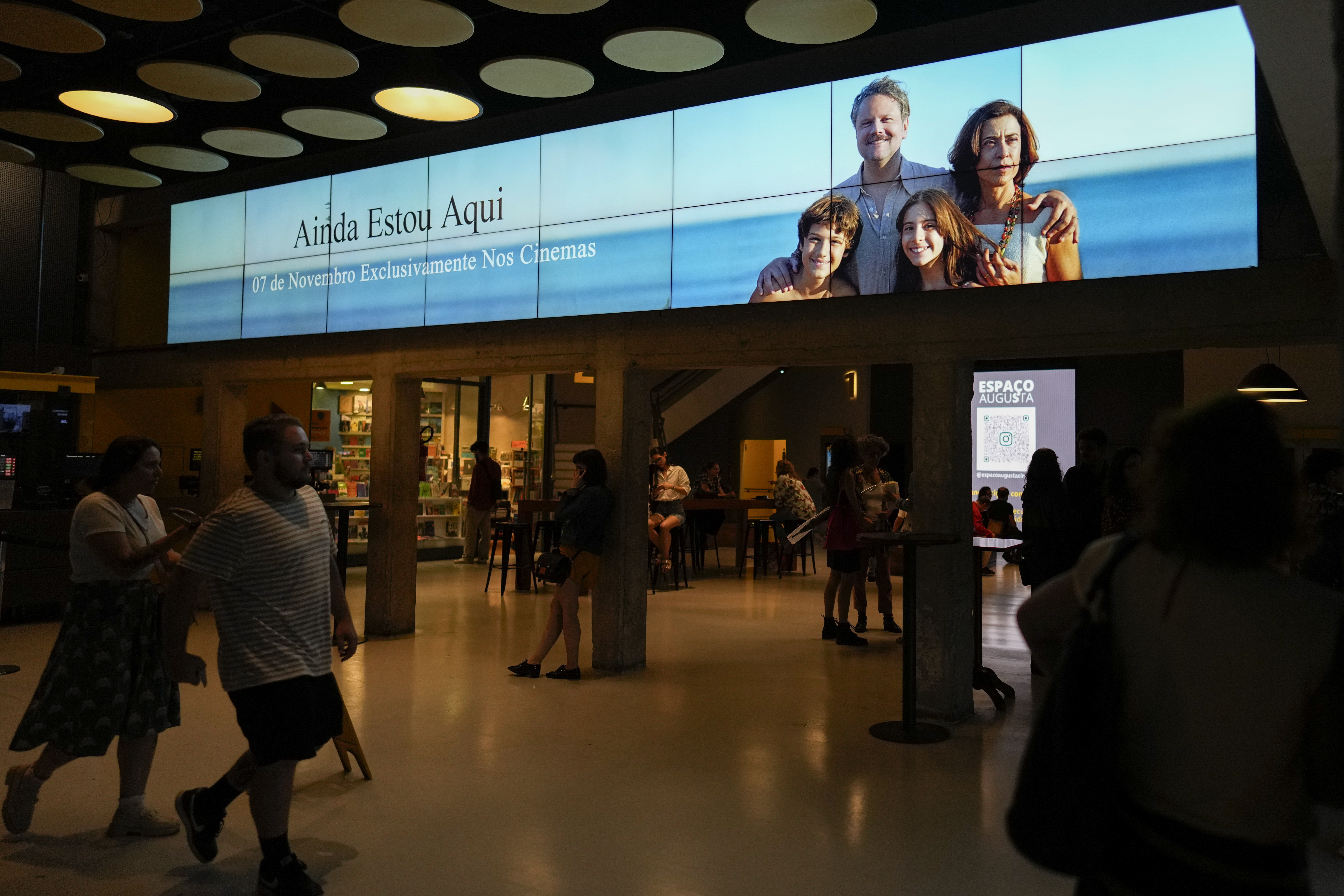 A video display shows a banner for the film I'm Still Here