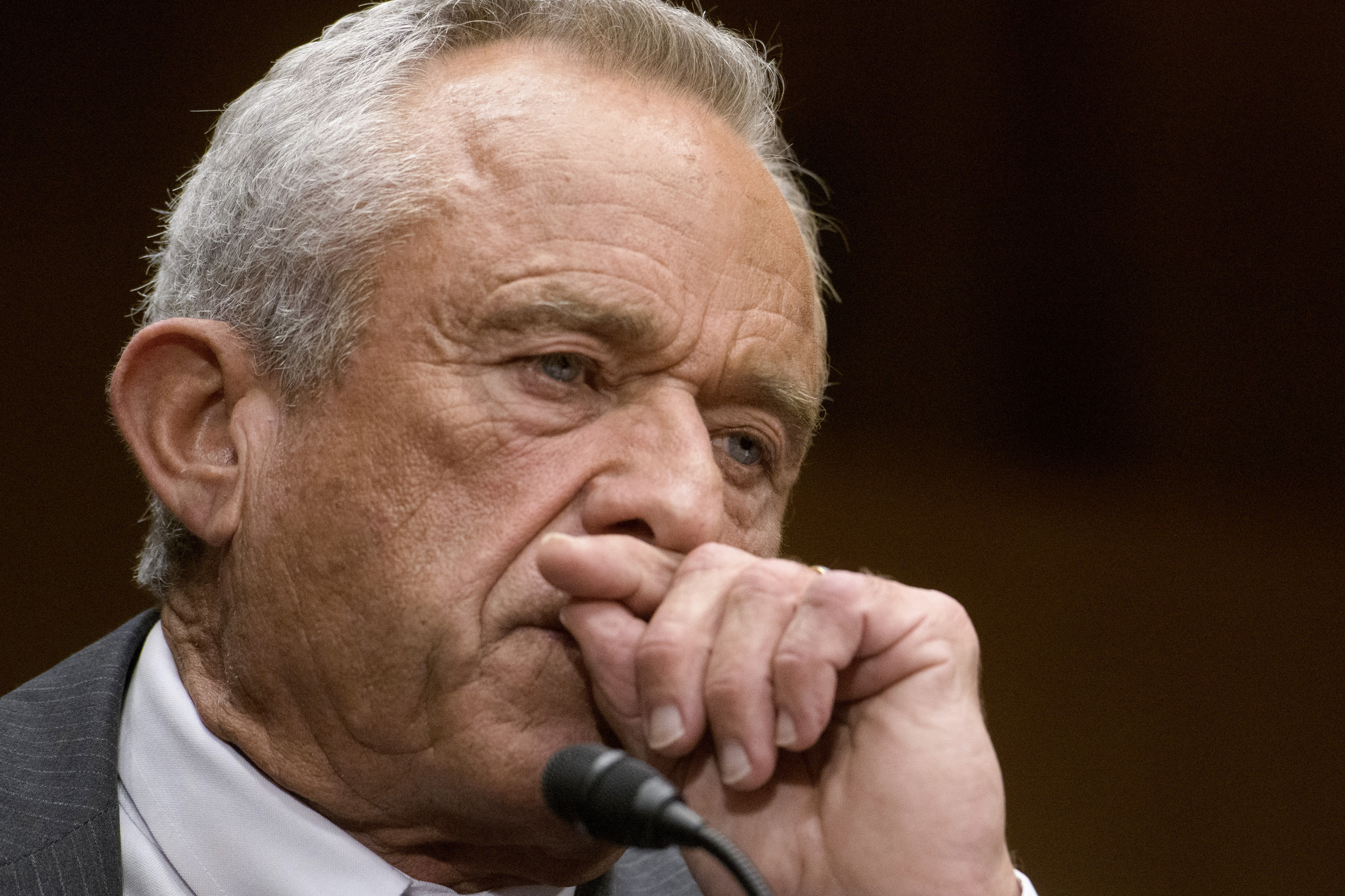 Robert F Kennedy Jr, leaning his head on his hand.