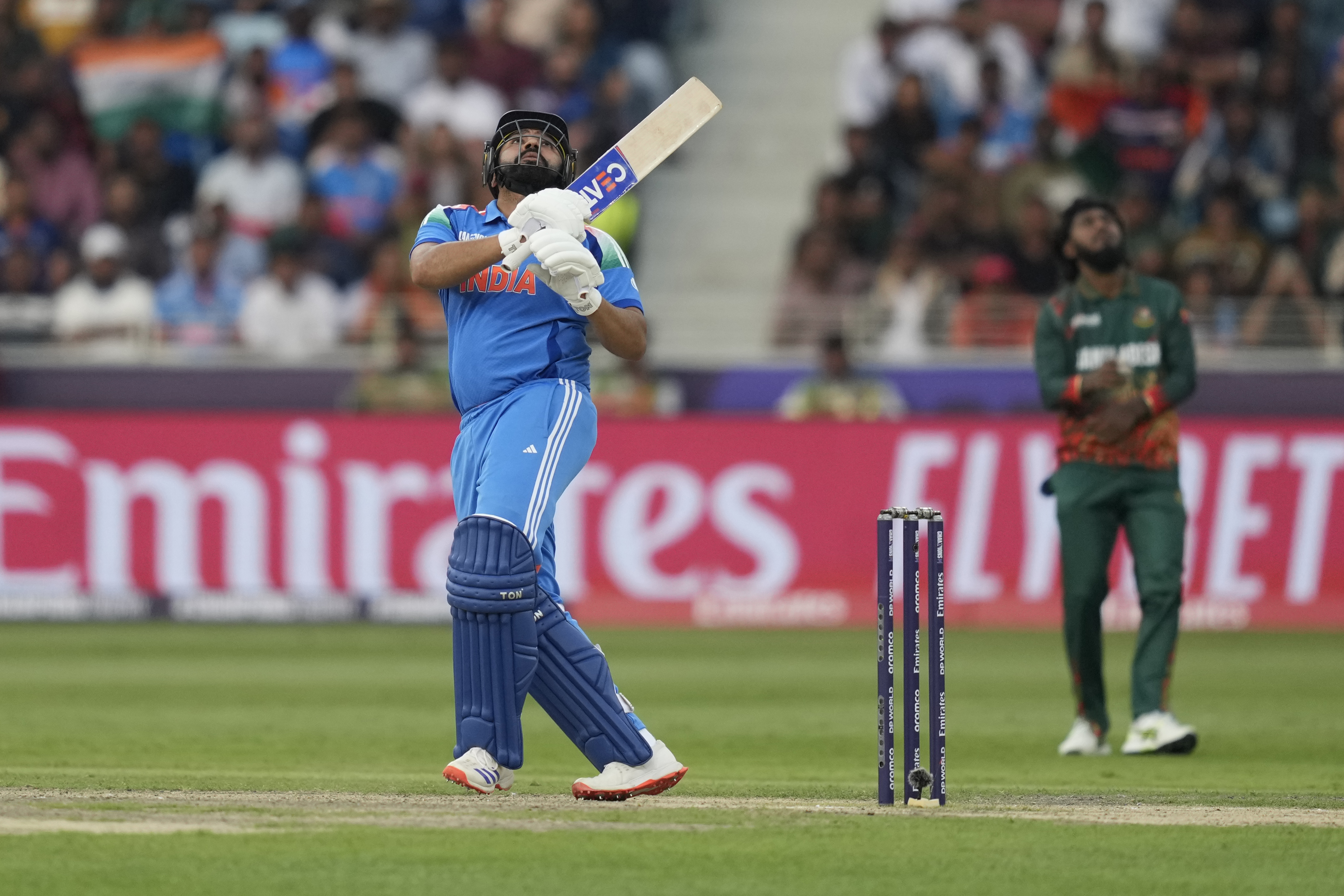 India's captain Rohit Sharma looks skywards to watch the ball just before he was caught during the ICC Champions Trophy cricket match between India and Bangladesh at Dubai International Cricket Stadium in Dubai, United Arab Emirates, Thursday, Feb. 20, 2025. (AP Photo/Altaf Qadri)