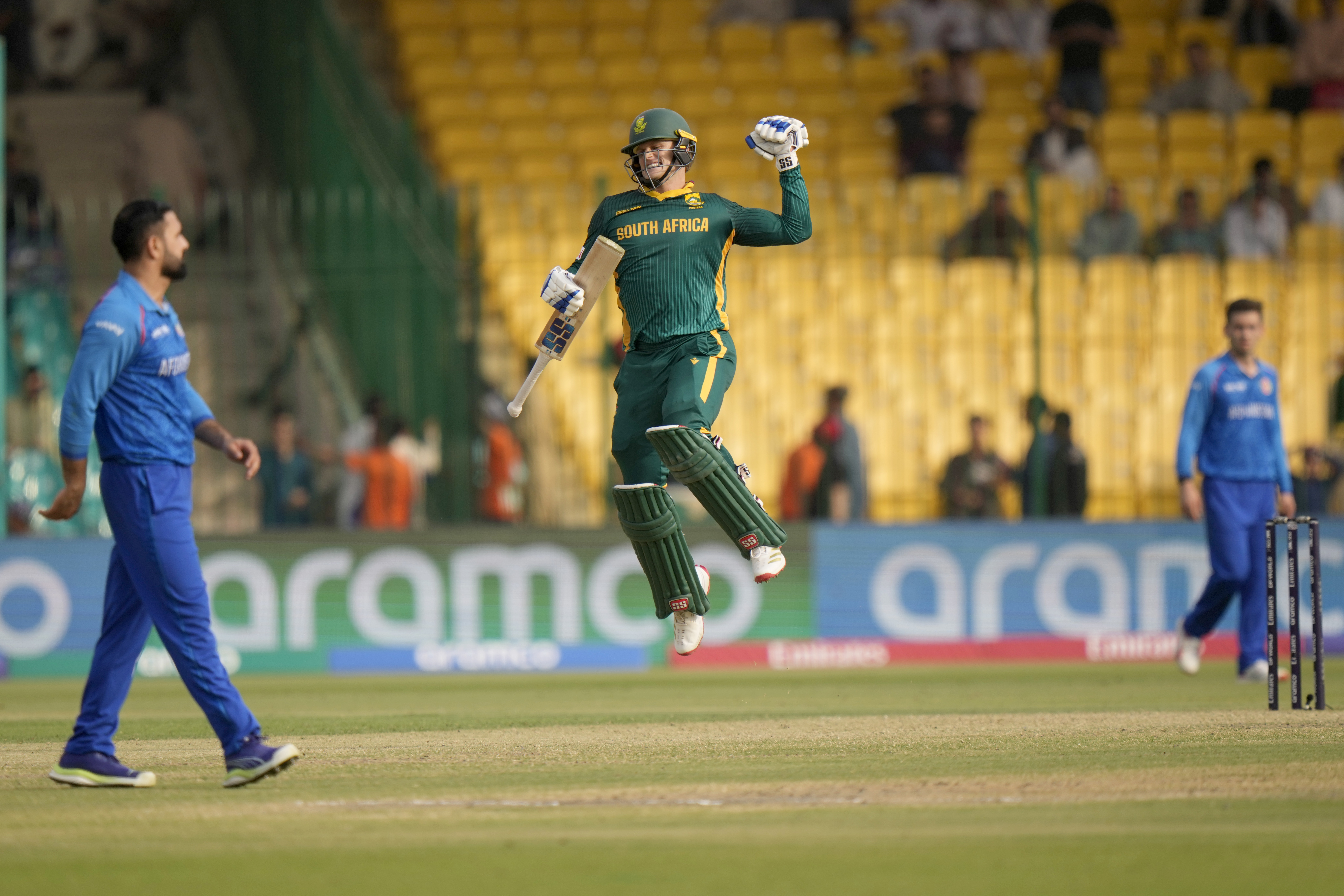 South Africa's Ryan Rickelton, center, celebrates after scoring century during the ICC Champions Trophy cricket match between Afghanistan and South Africa, in Karachi, Pakistan Friday, Feb. 21, 2025. (AP Photo/Anjum Naveed)