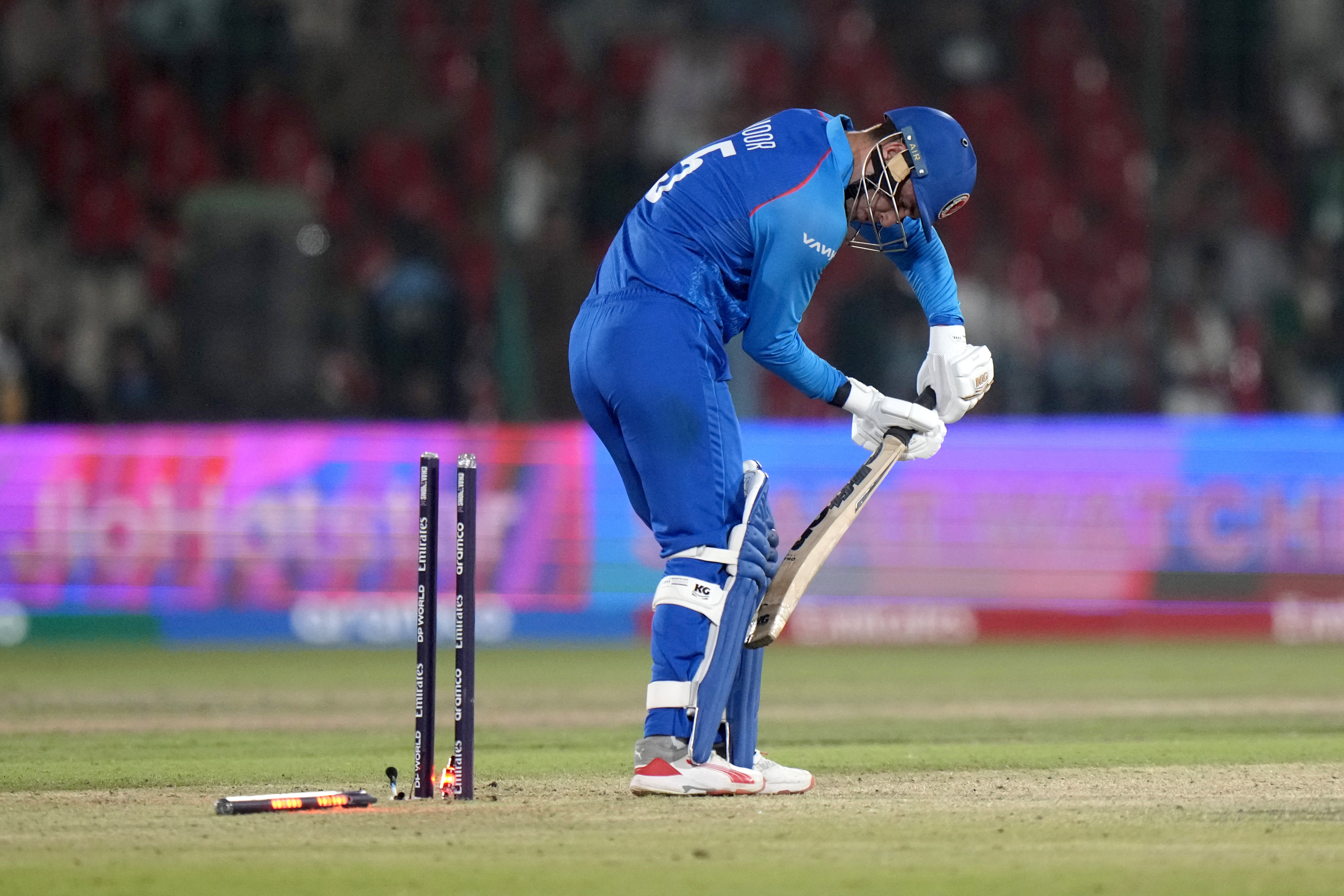 Afghanistan's Noor Ahmad reacts after his dismissal during the ICC Champions Trophy cricket match between Afghanistan and South Africa, in Karachi, Pakistan Friday, Feb. 21, 2025. (AP Photo/Anjum Naveed)