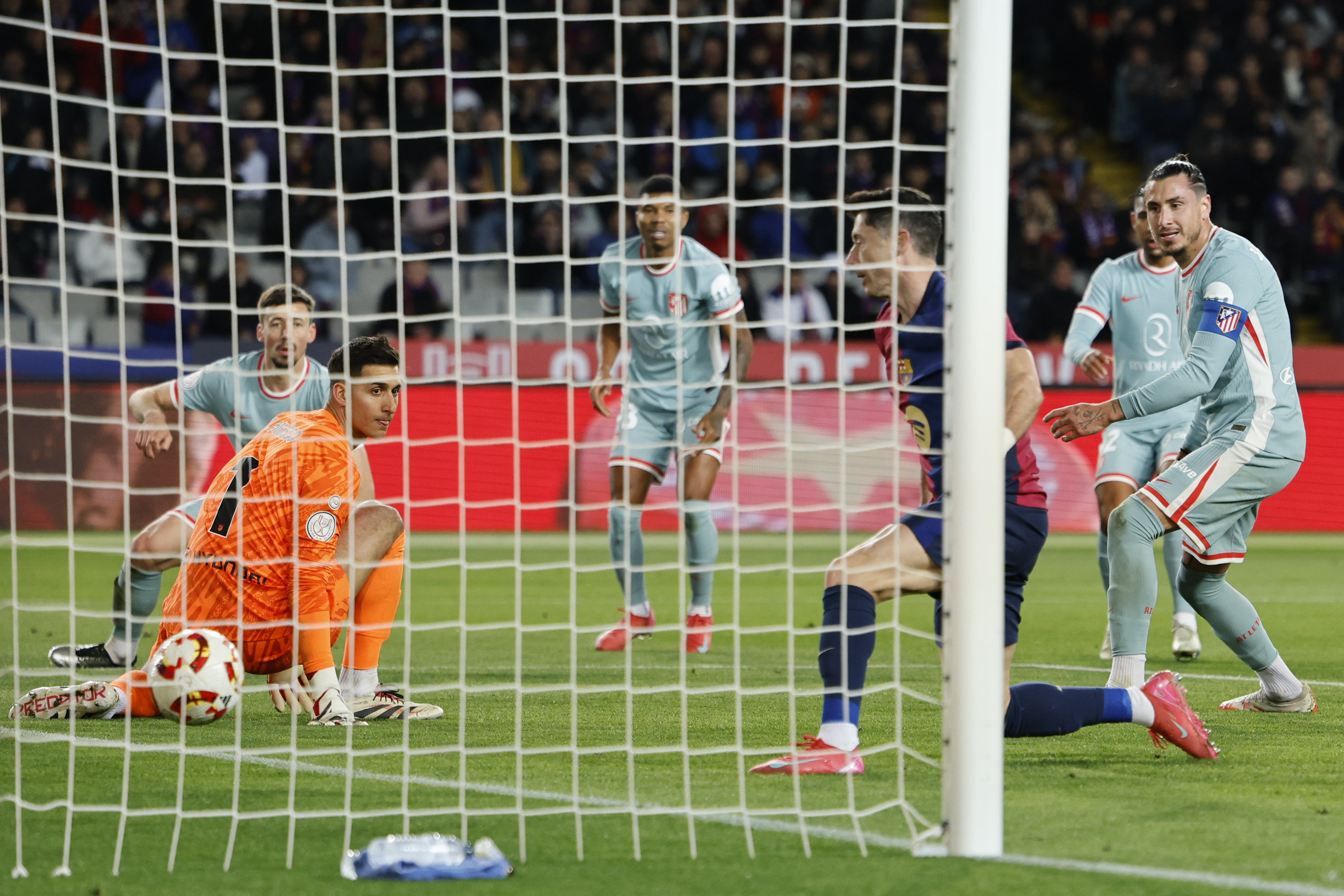 Barcelona's Robert Lewandowski scores during a Spanish Copa del Rey, or King's Cup, the semi-final soccer match between Barcelona and Atletico Madrid in Barcelona, Spain, Wednesday, Feb. 26, 2025. AP Photo/Joan Monfort)