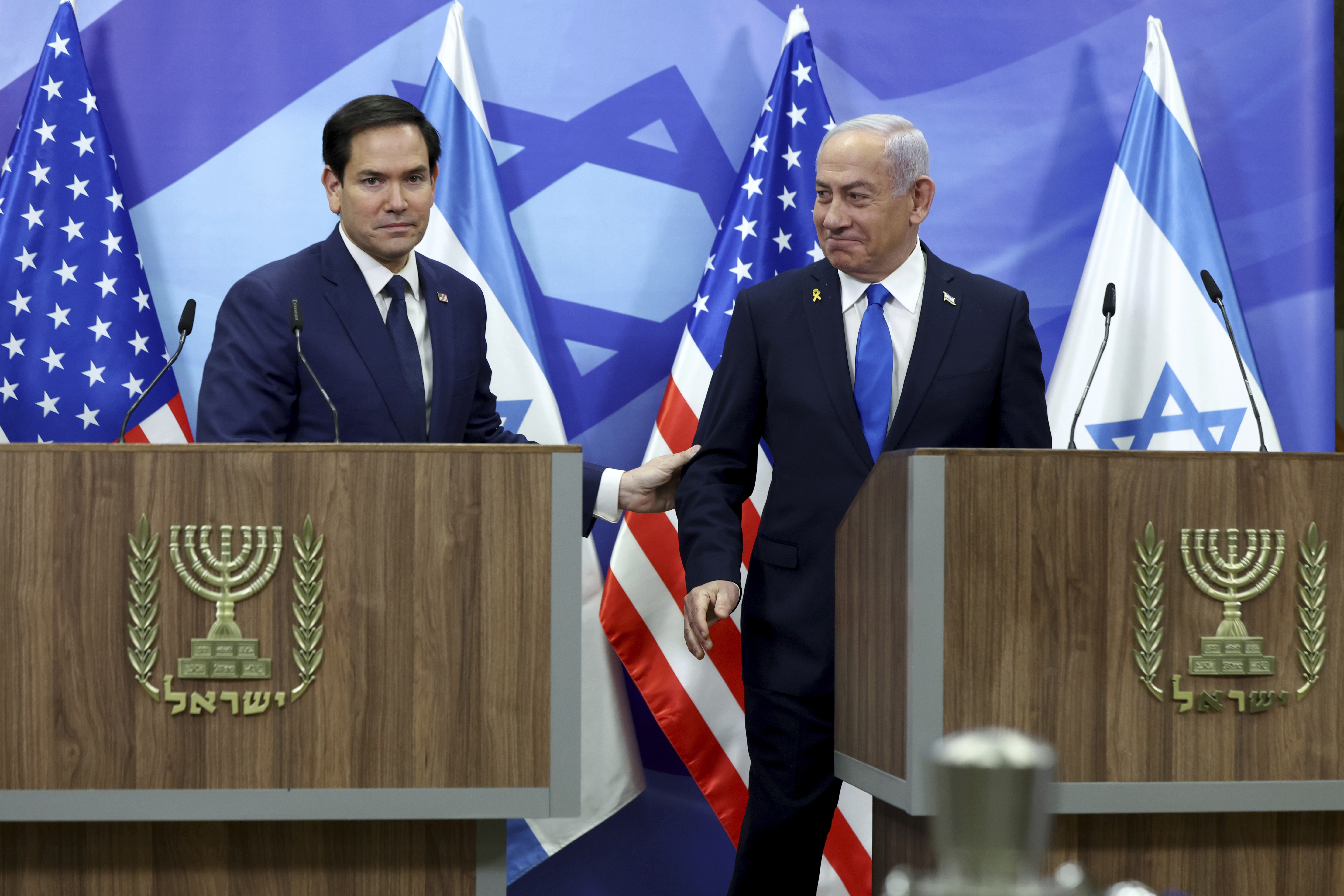 U.S. Secretary of State Marco Rubio, left, and Israeli Prime Minister Benjamin Netanyahu shake hands during a news conference at the Prime Minister's office in Jerusalem, Israel, Sunday, Feb. 16, 2025. (Evelyn Hockstein/Pool Photo via AP)