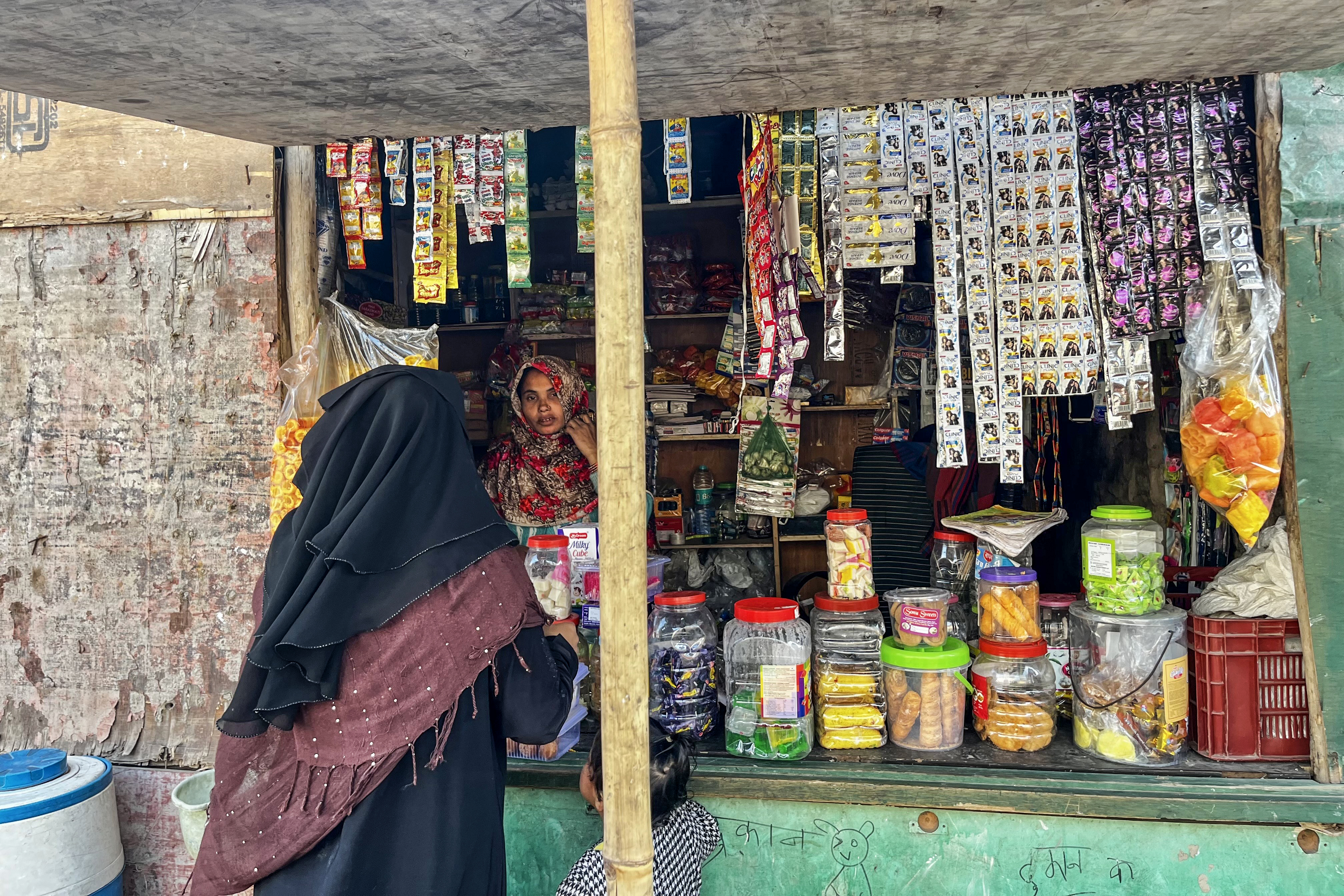 One of the few woman with her tinshed stalls attached to her makeshift bed in Madanpur camp in Delhi.