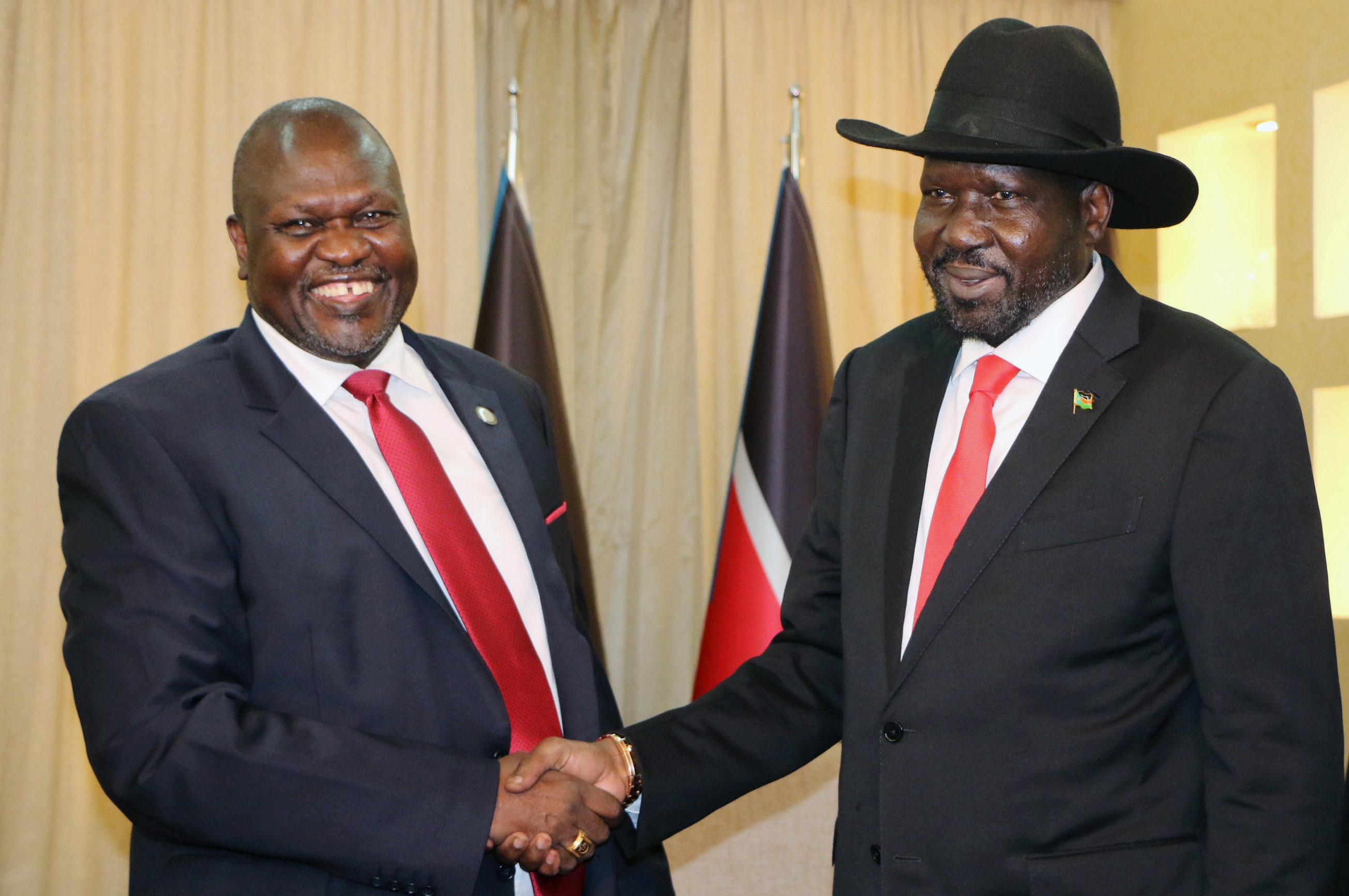 South Sudan's President Salva Kiir Mayardit shakes hands with ex-vice president and former rebel leader Riek Machar during their meeting in Juba, South Sudan October 19, 2019. REUTERS/Jok Solomun