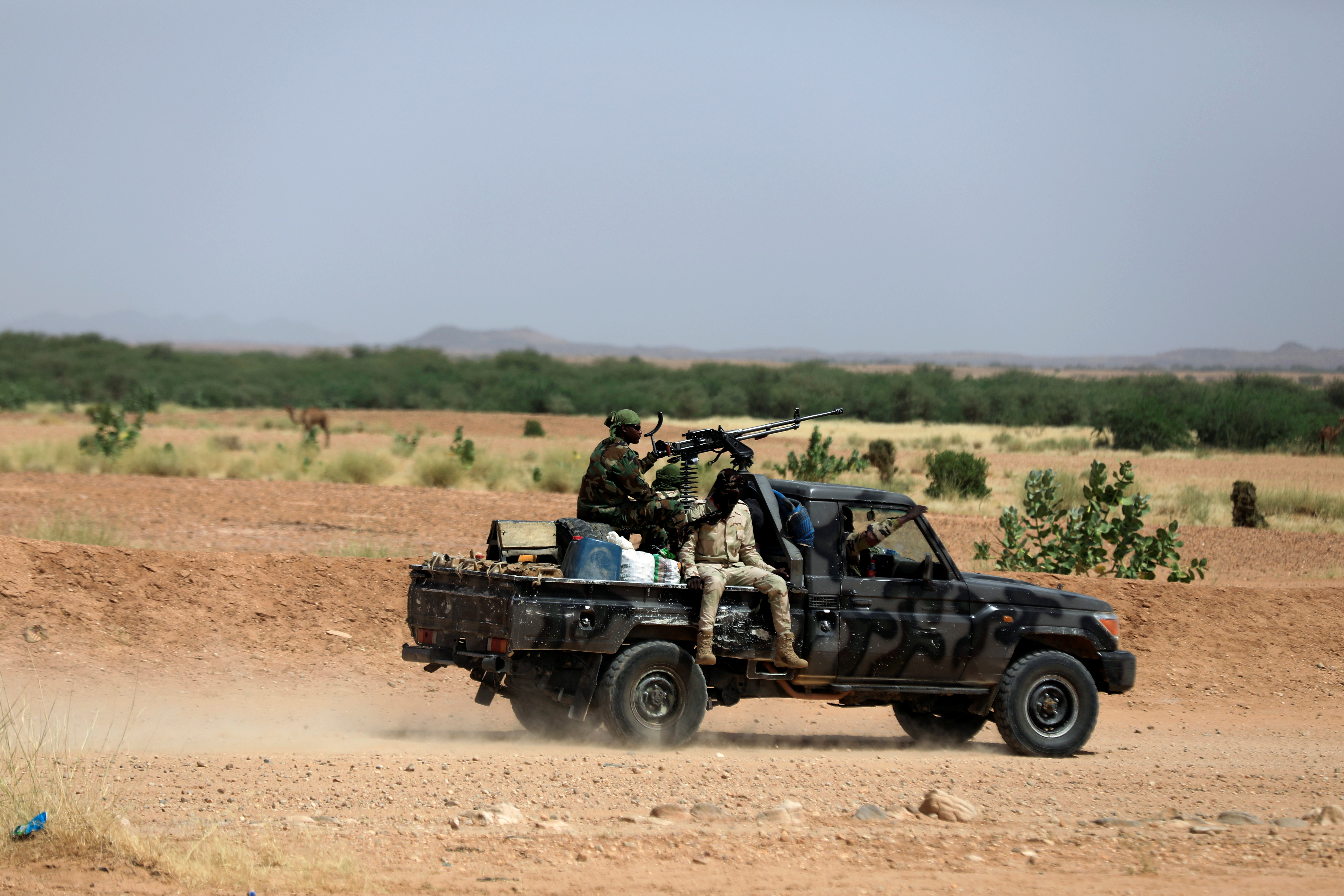 Nigerian army soldiers board a pickup to escort Nigerians heading north towards Libya as they leave Agadez, Niger October 29, 2019. Picture taken October 29, 2019. REUTERS/Zohra Bensemra