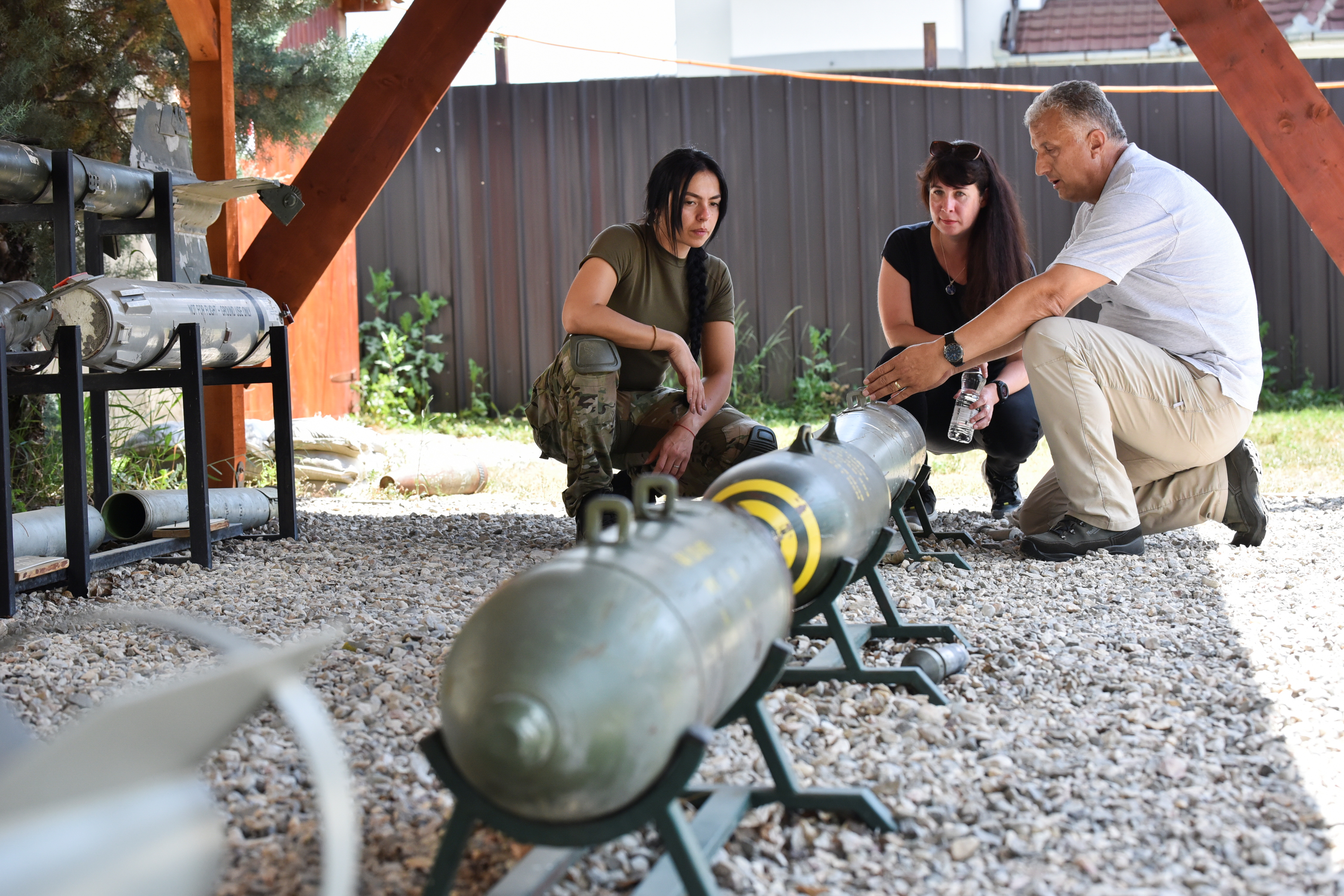 A trainer guides women in the removal of landmines and other unexploded ordnances.