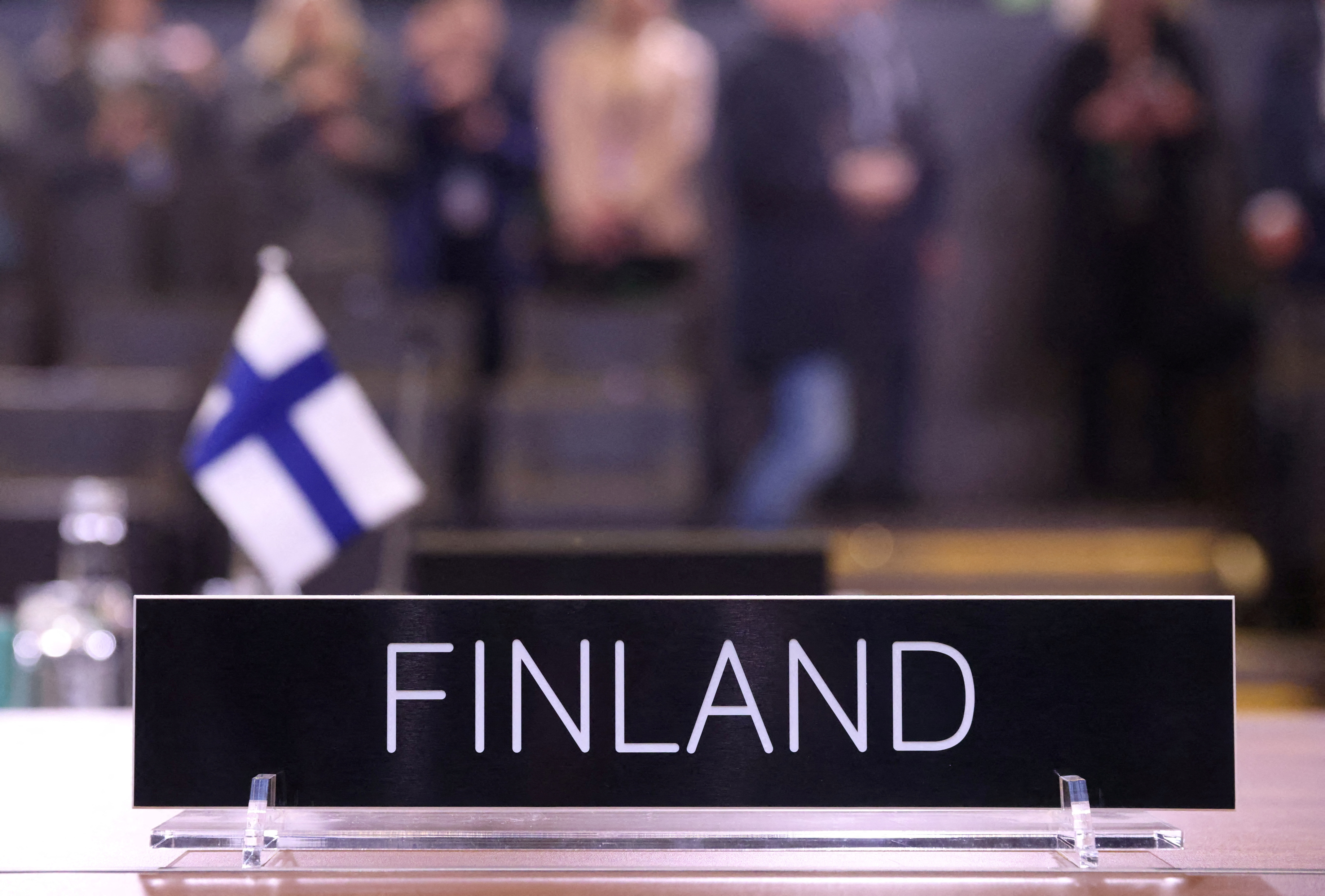 A plaque along with Finland's flag is seen at a roundtable discussion during a joining ceremony at the NATO foreign ministers' meeting at the Alliance's headquarters in Brussels, Belgium April 4, 2023. REUTERS/Johanna Geron