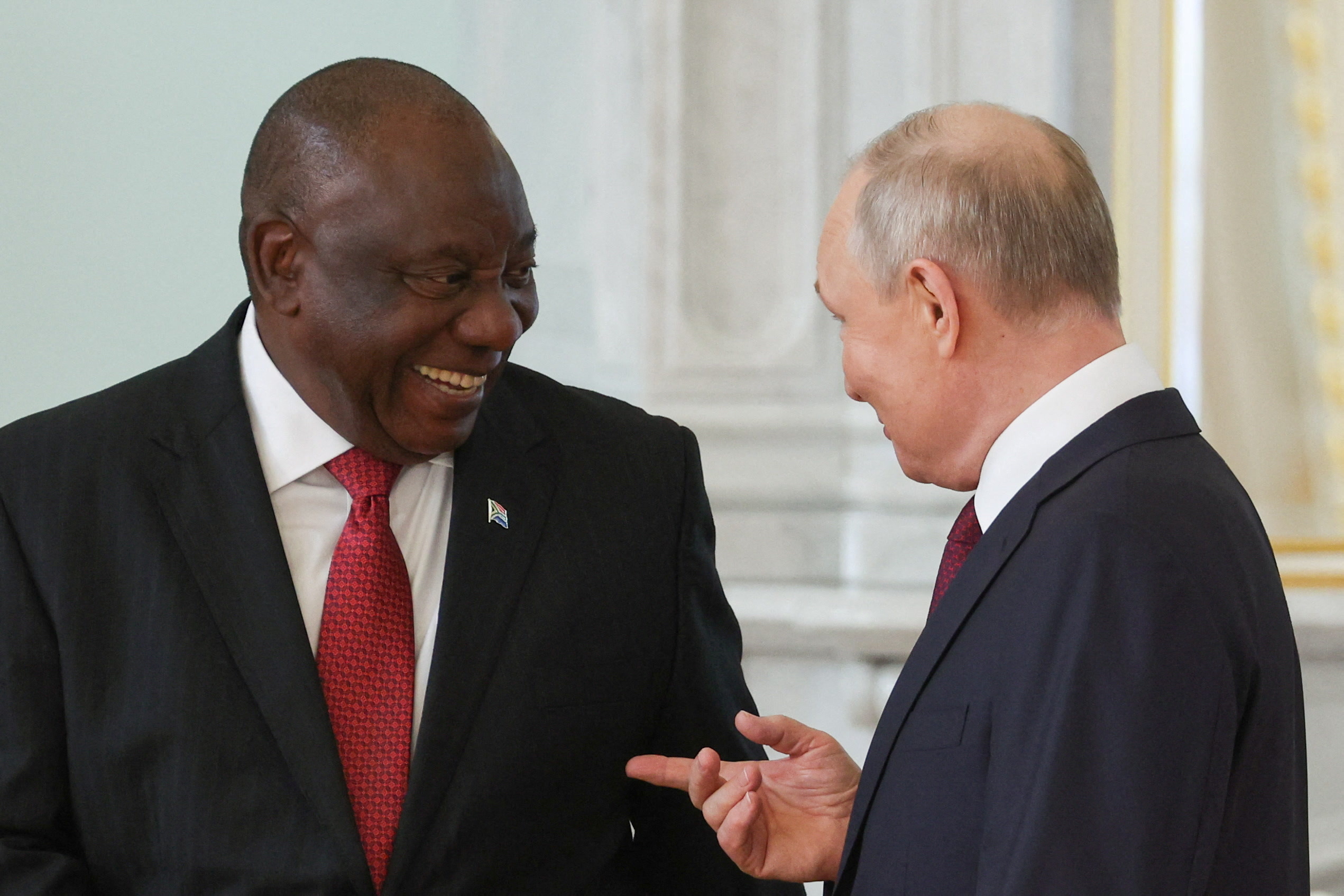 Russian President Vladimir Putin and South African President Cyril Ramaphosa react while speaking during their meeting following the Russia-Africa summit in Saint Petersburg, Russia, July 29, 2023. Sergei Bobylyov/TASS Host Photo Agency via REUTERS ATTENTION EDITORS - THIS IMAGE WAS PROVIDED BY A THIRD PARTY. MANDATORY CREDIT.
