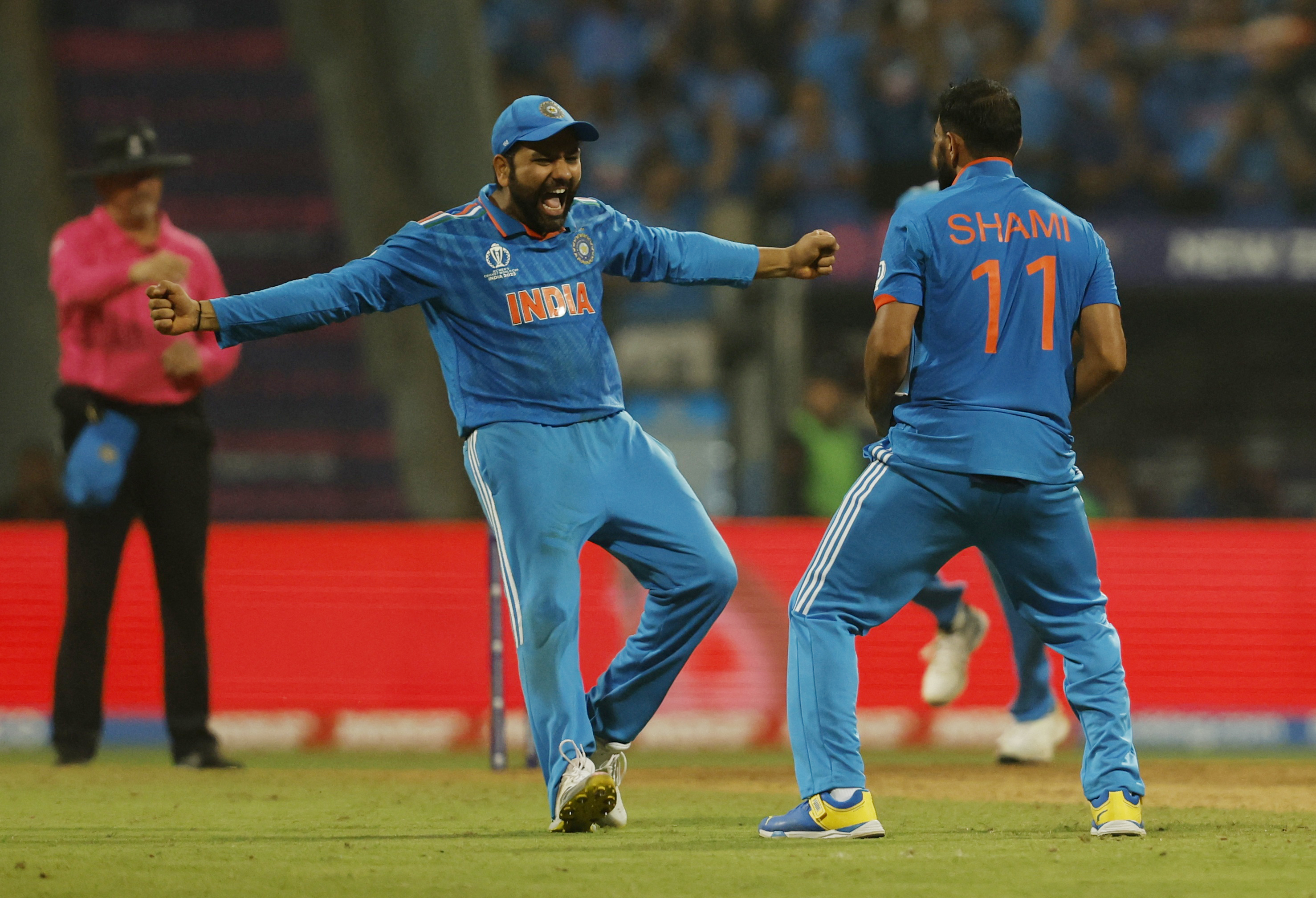 Cricket - ICC Cricket World Cup 2023 - Semi-Final - India v New Zealand - Wankhede Stadium, Mumbai, India - November 15, 2023 India's Mohammed Shami celebrates with Rohit Sharma after taking the lbw wicket of New Zealand's Tom Latham REUTERS/Francis Mascarenhas