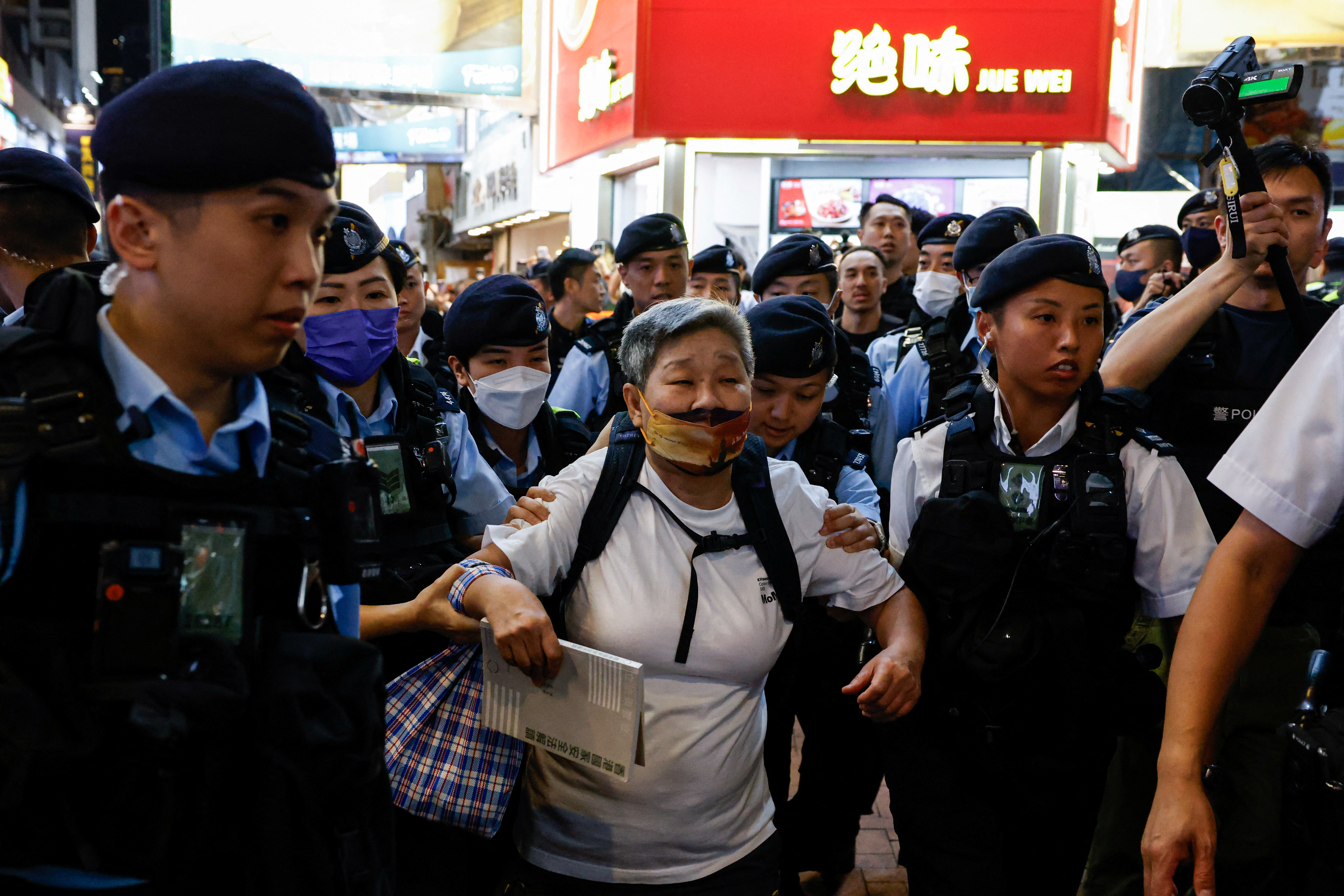 HK police detain a pro-democracy demonstrator