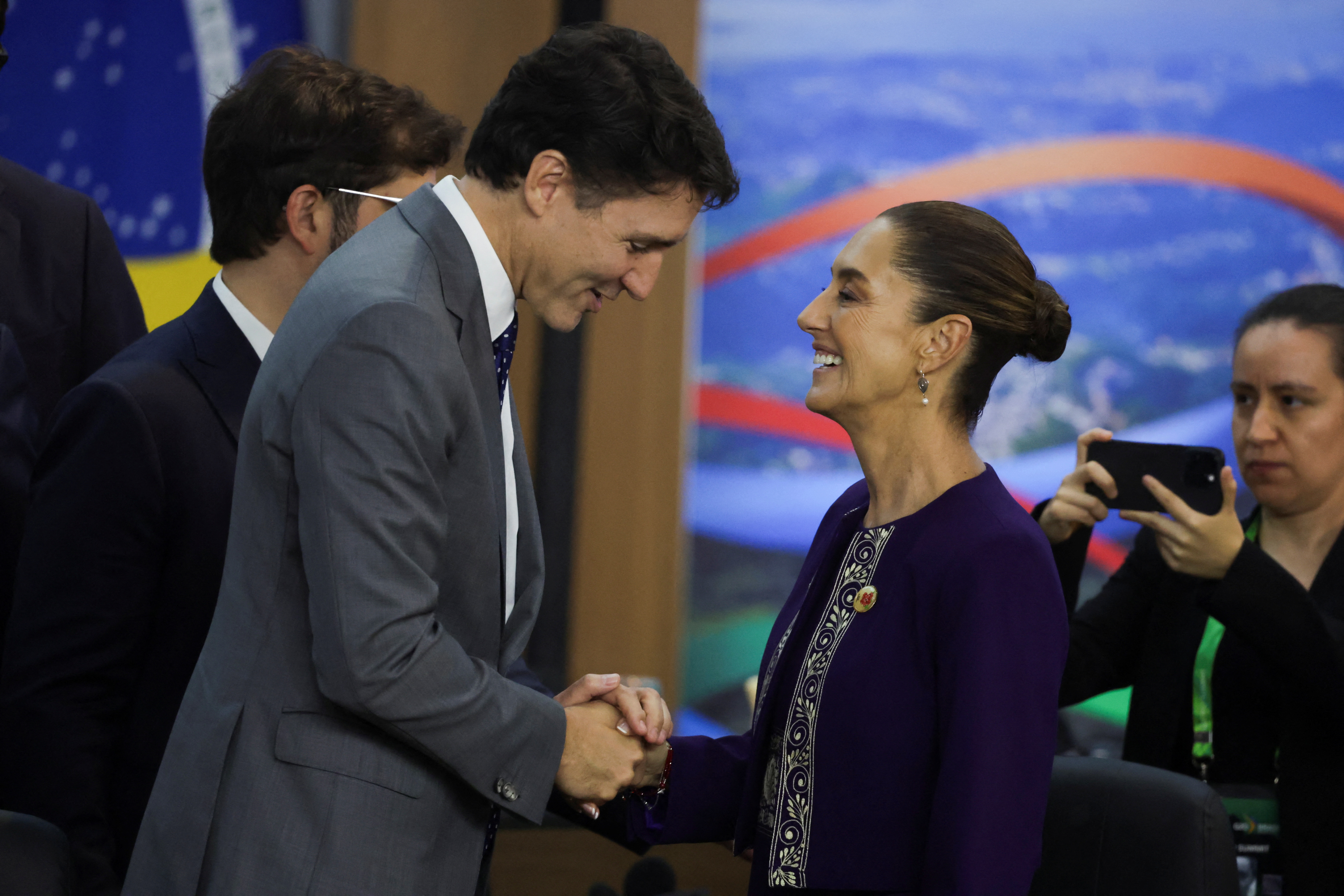 Canada's Prime Minister Justin Trudeau and Mexico's President Claudia Sheinbaum shake hands during a G20 summit.