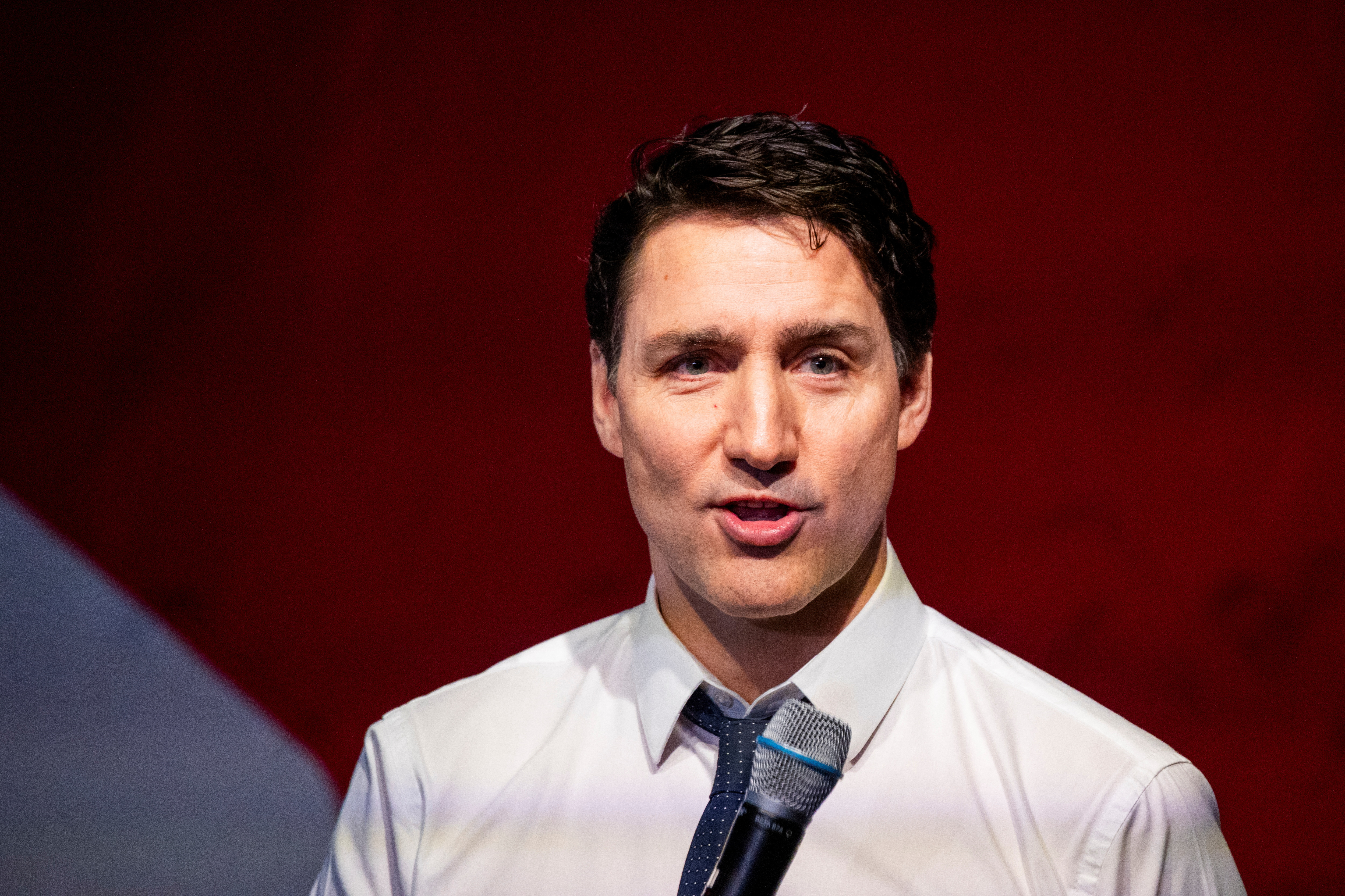 Canadian Prime Minister Justin Trudeau speaks into a microphone
