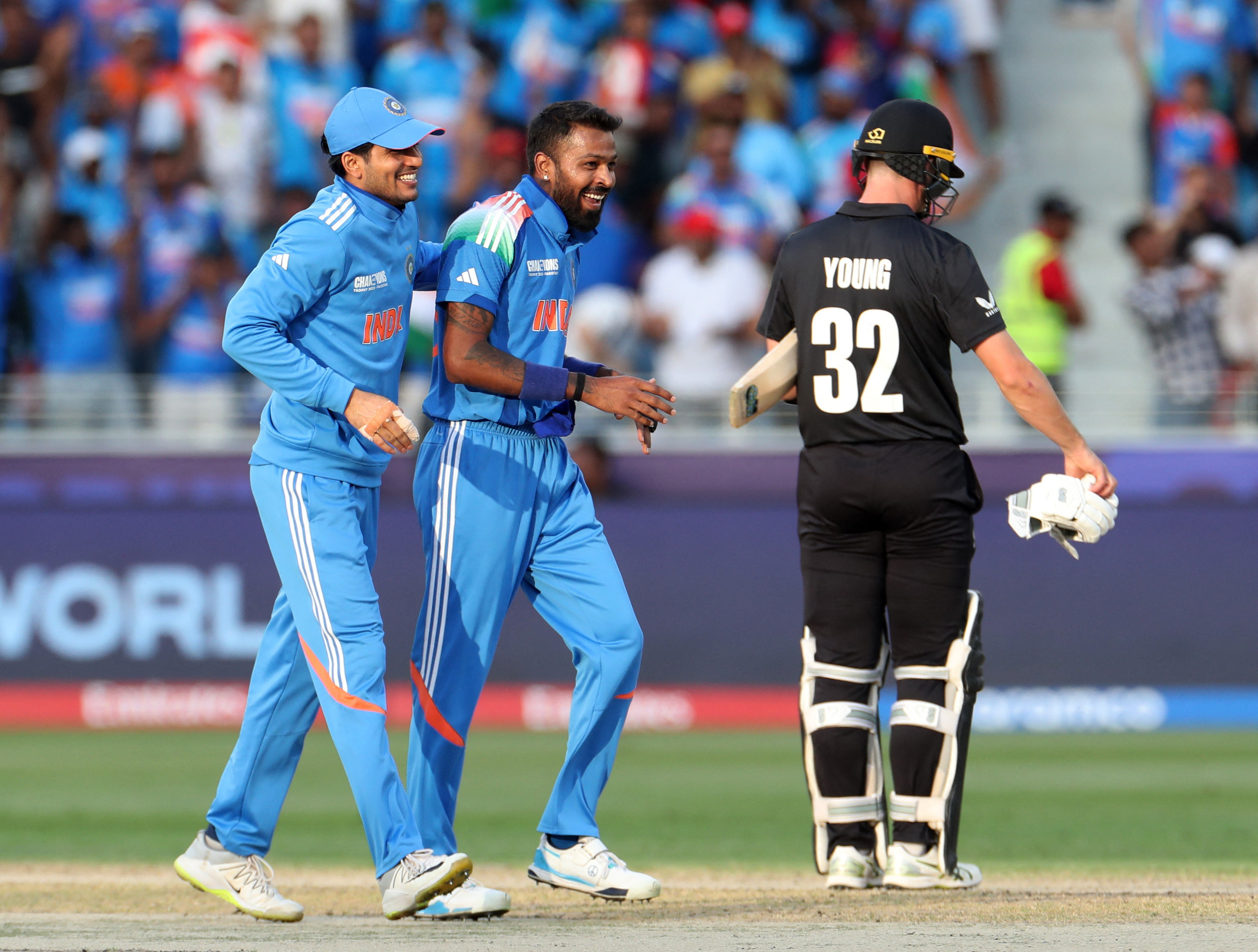 Cricket - ICC Men's Champions Trophy - Group A - India v New Zealand - Dubai International Stadium, Dubai, United Arab Emirates - March 2, 2025 India's Hardik Pandya celebrates with Shubman Gill after taking the wicket of New Zealand's Rachin Ravindra, caught out by Axar Patel REUTERS/Satish Kumar
