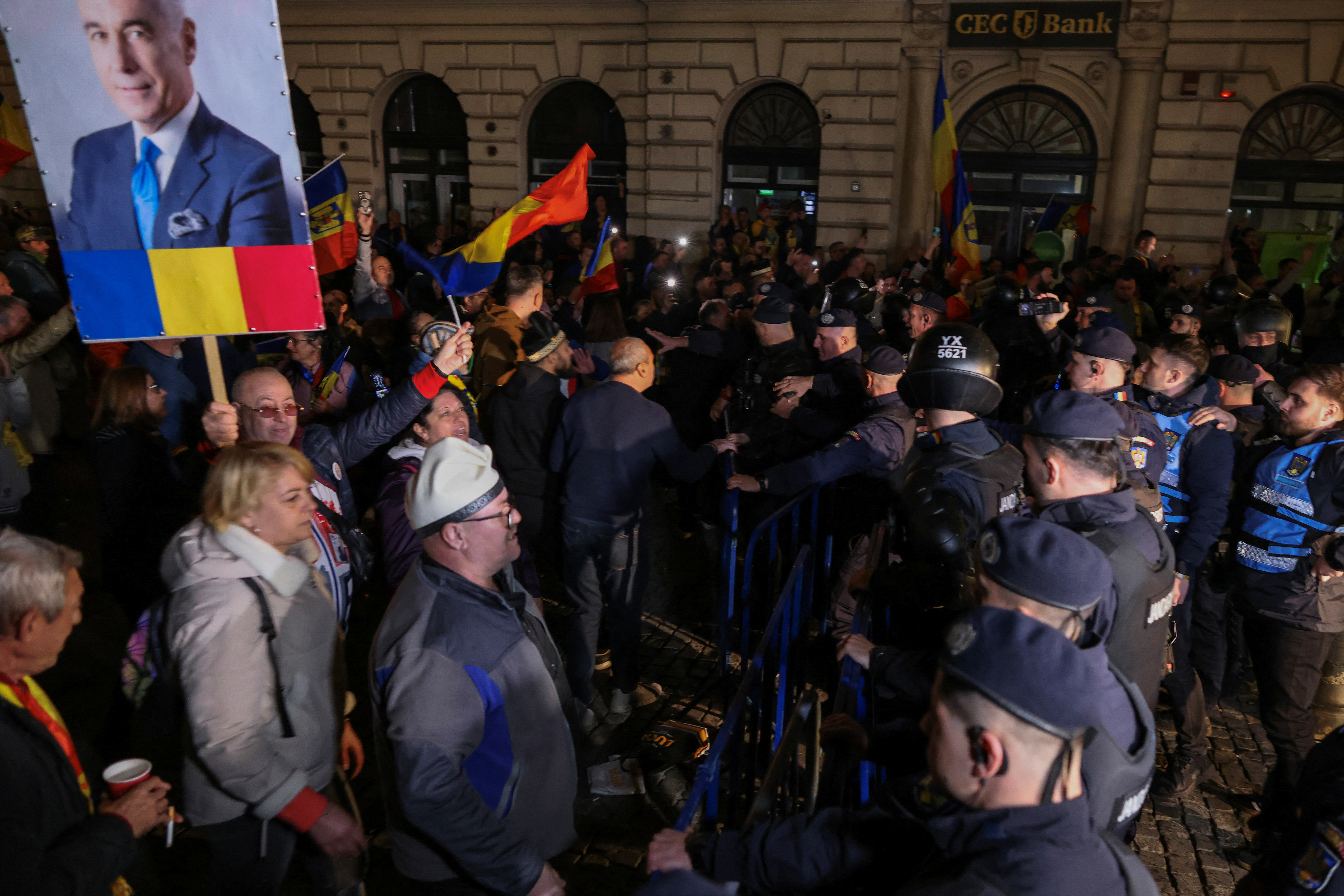 Supporters of far-right candidate Calin Georgescu gather outside Romania's central electoral bureau, after the rejection of his candidacy for the May presidential ballot re-run, in Bucharest, Romania