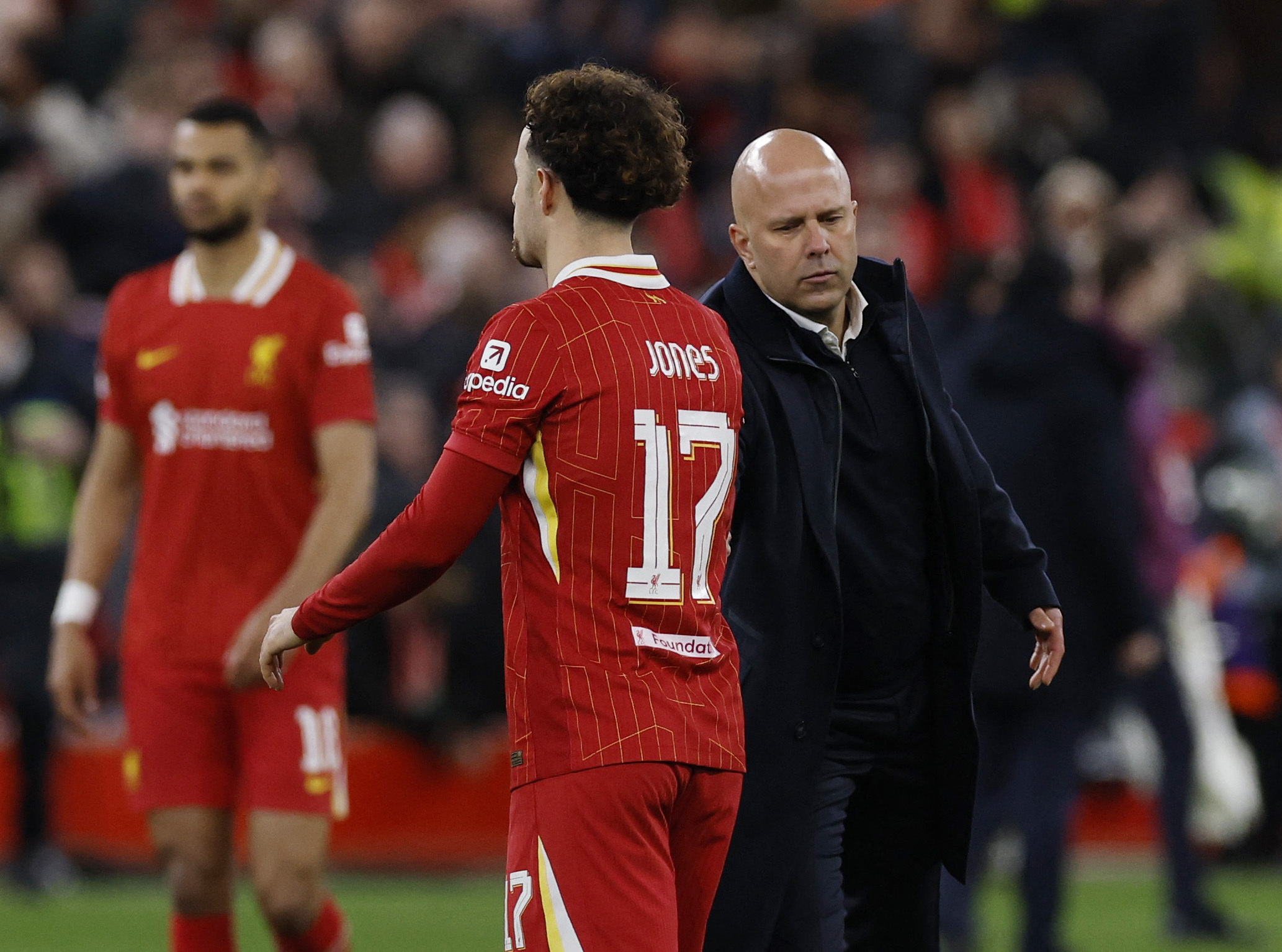 Soccer Football - Champions League - Round of 16 - Second Leg - Liverpool v Paris St Germain - Anfield, Liverpool, Britain - March 11, 2025 Liverpool's Curtis Jones and manager Arne Slot look dejected after the match Action Images via Reuters/Jason Cairnduff