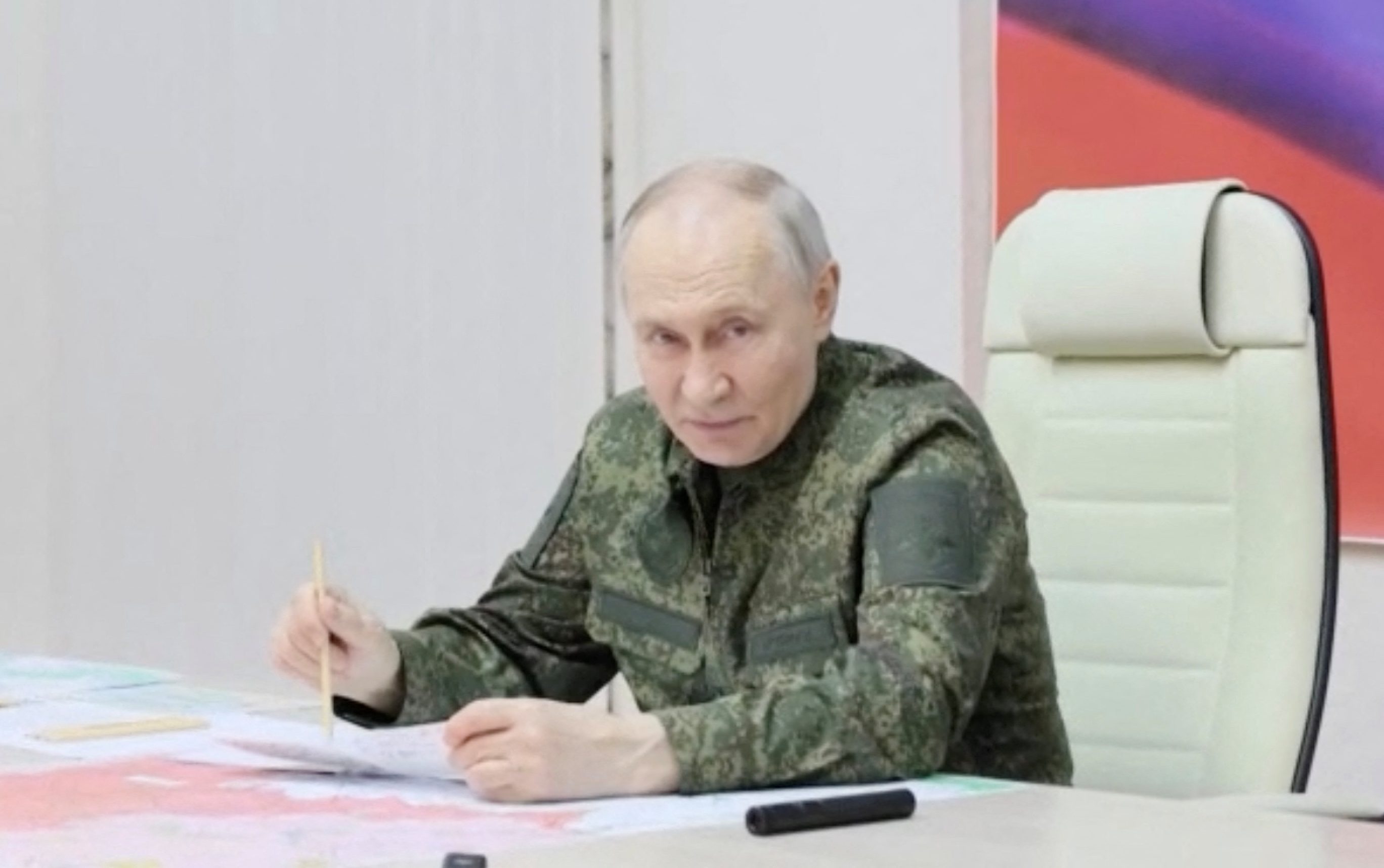 Russia's President Vladimir Putin addresses commanders as he visits a control centre of the Russian armed forces.