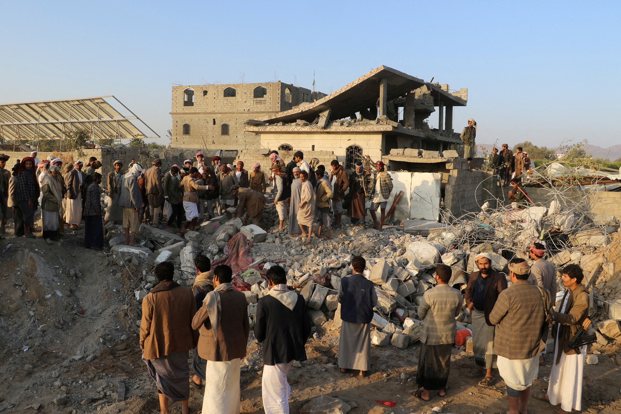 People gather at the site of a house hit by a U.S. strike in Saada, Yemen