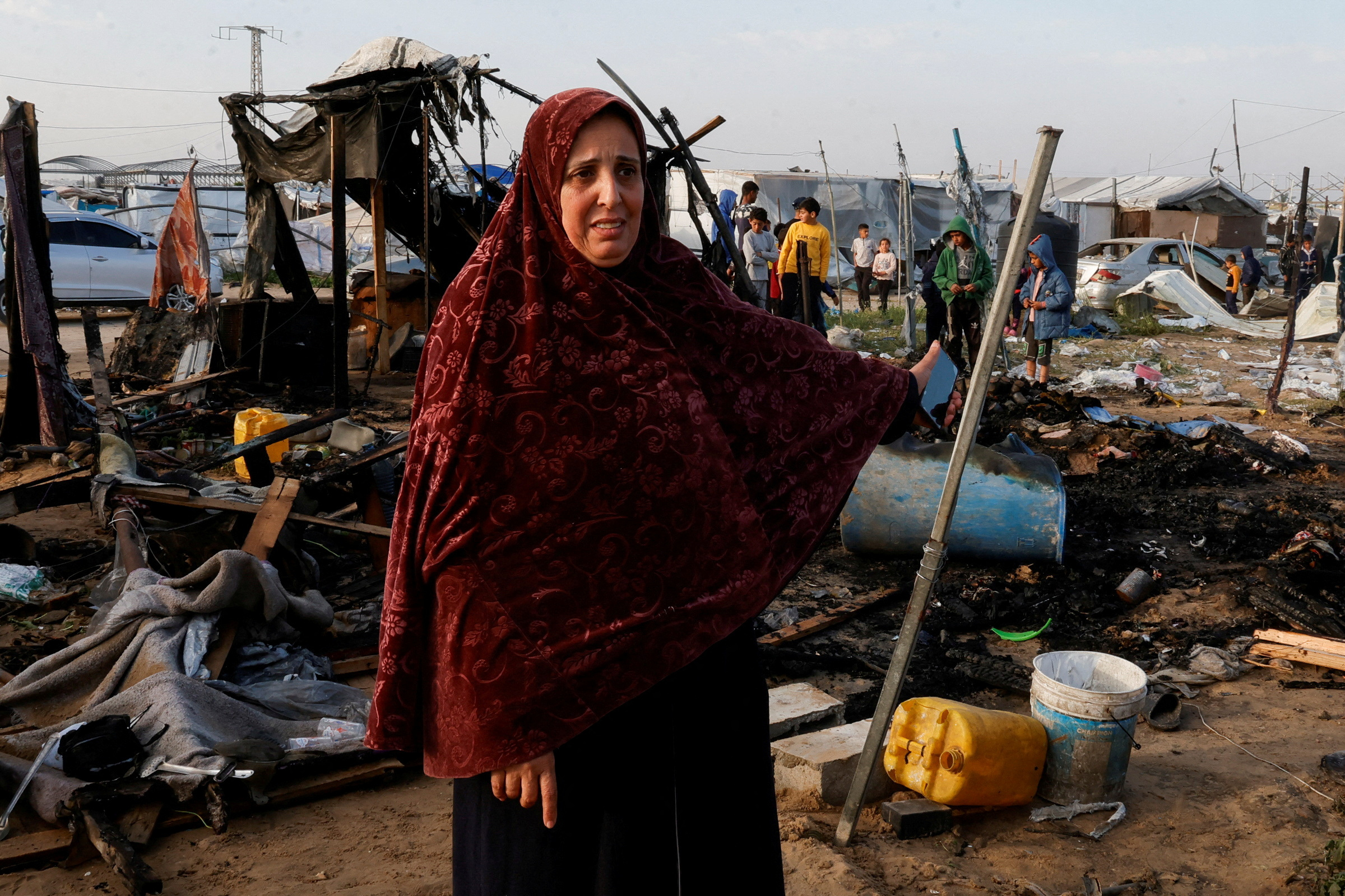 A Palestinian woman in a tent camp housing displaced people in Al-Mawasi, Gaza