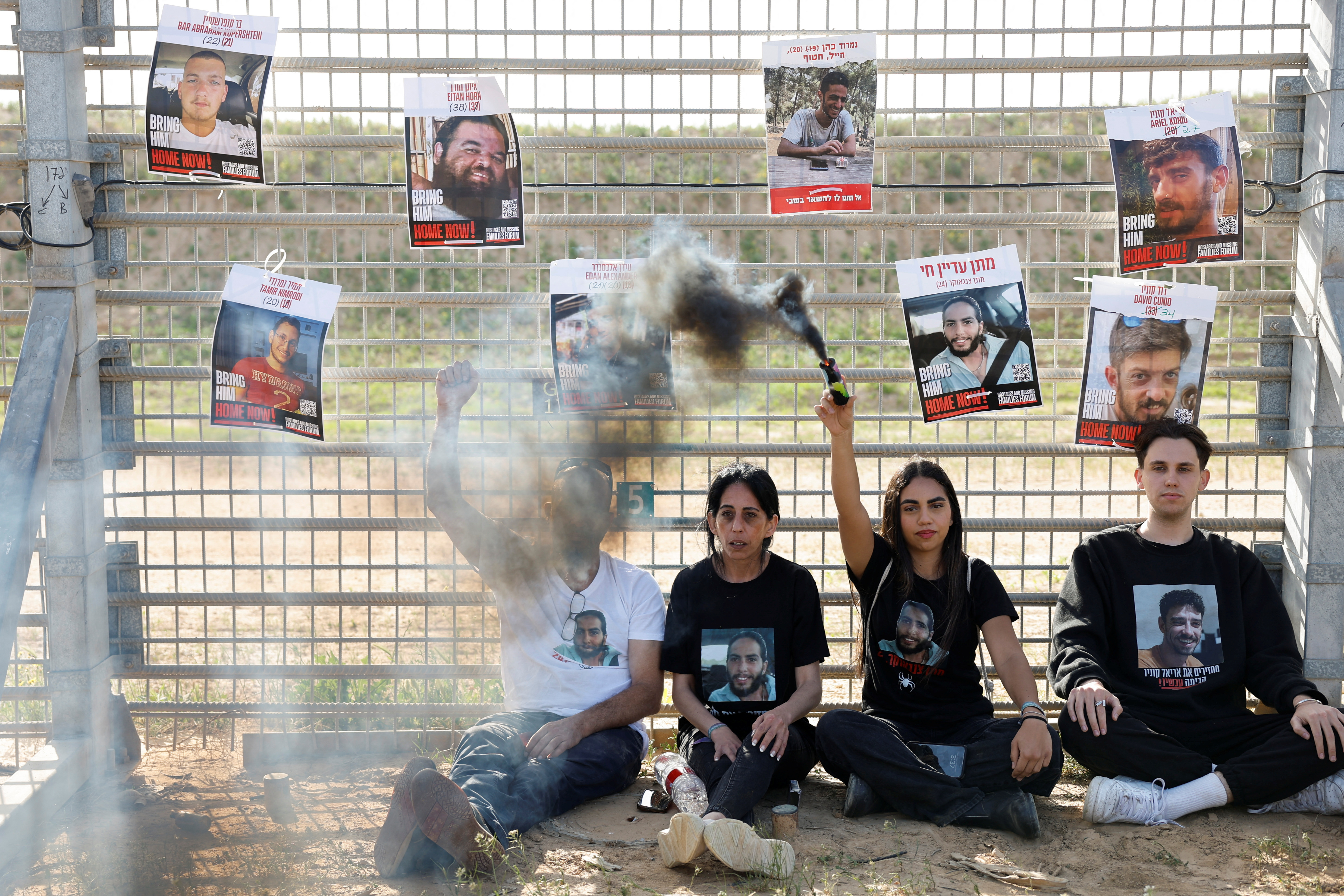 Einav Zangauker, mother of captive Matan Zangauker, who was kidnapped during the deadly October 7, 2023, during the deadly October 7, 2023 attack on Israel by Hamas, sits as posters of captives hang from the Israel-Gaza border fence