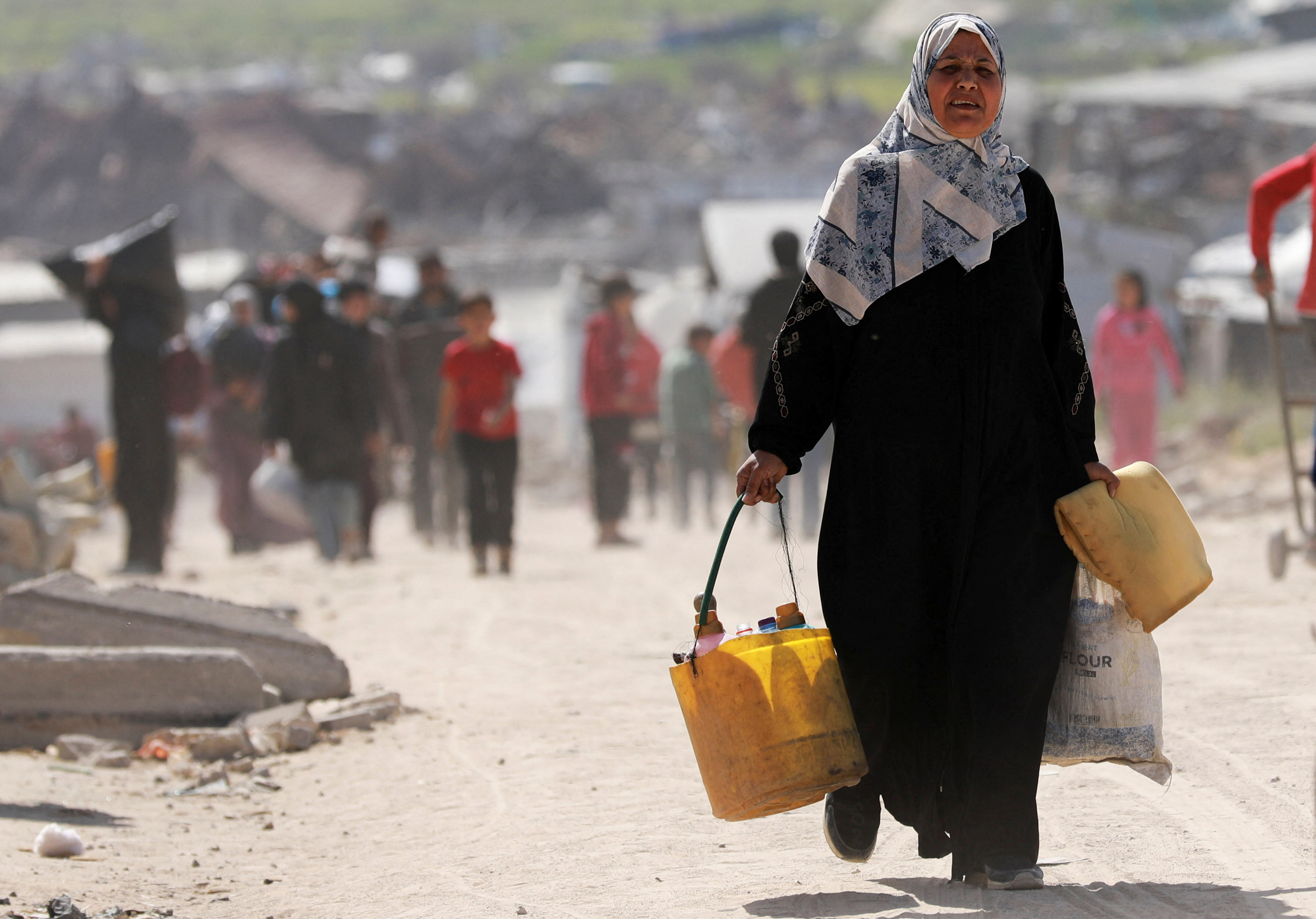 Palestinian woman carrying bags