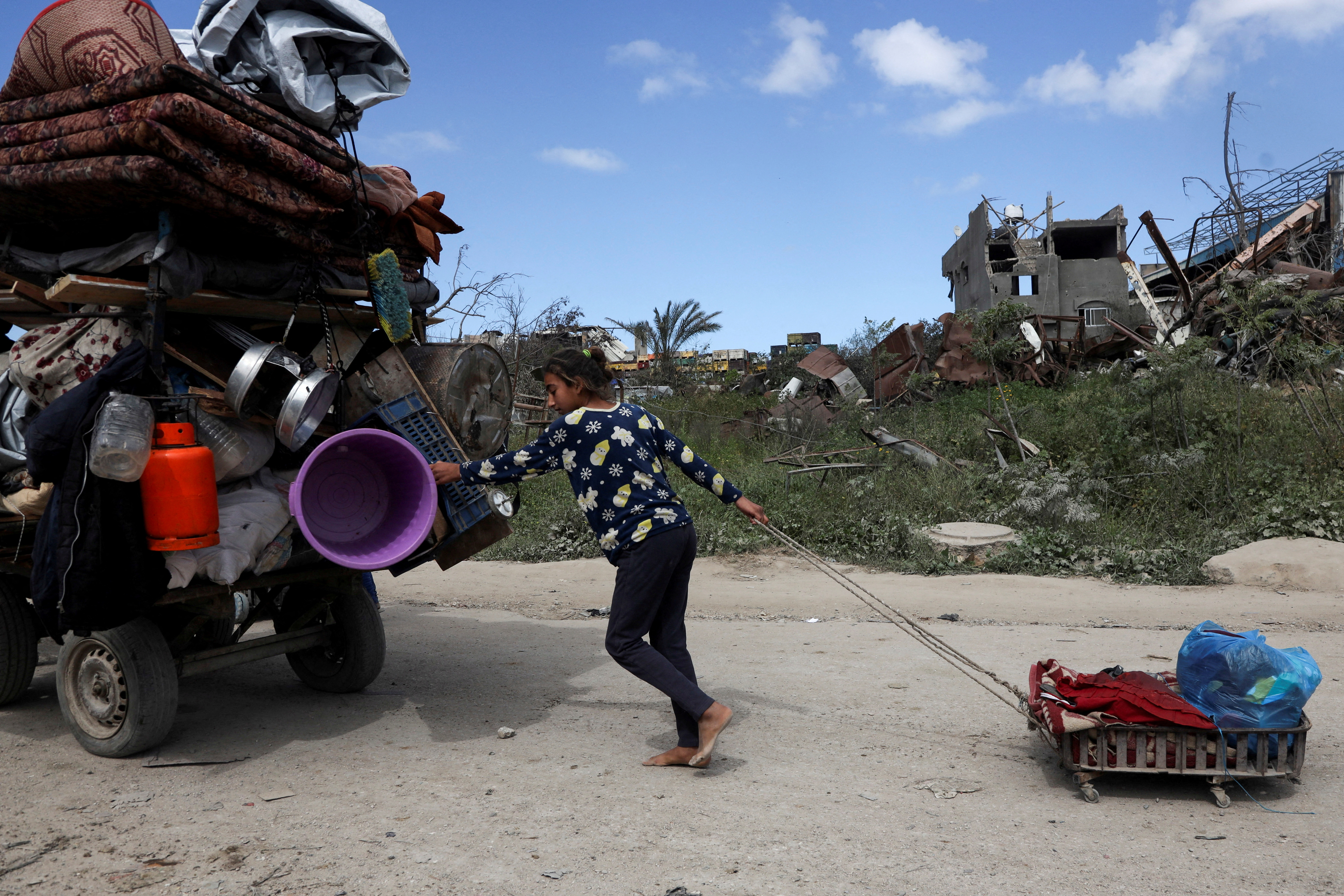 Palestinians flee their homes after the Israeli army issued forced displacement orders in Beit Hanoon in the northern Gaza Strip, March 19, 2025 [Abd Elhkeem Khaled/Reuters]