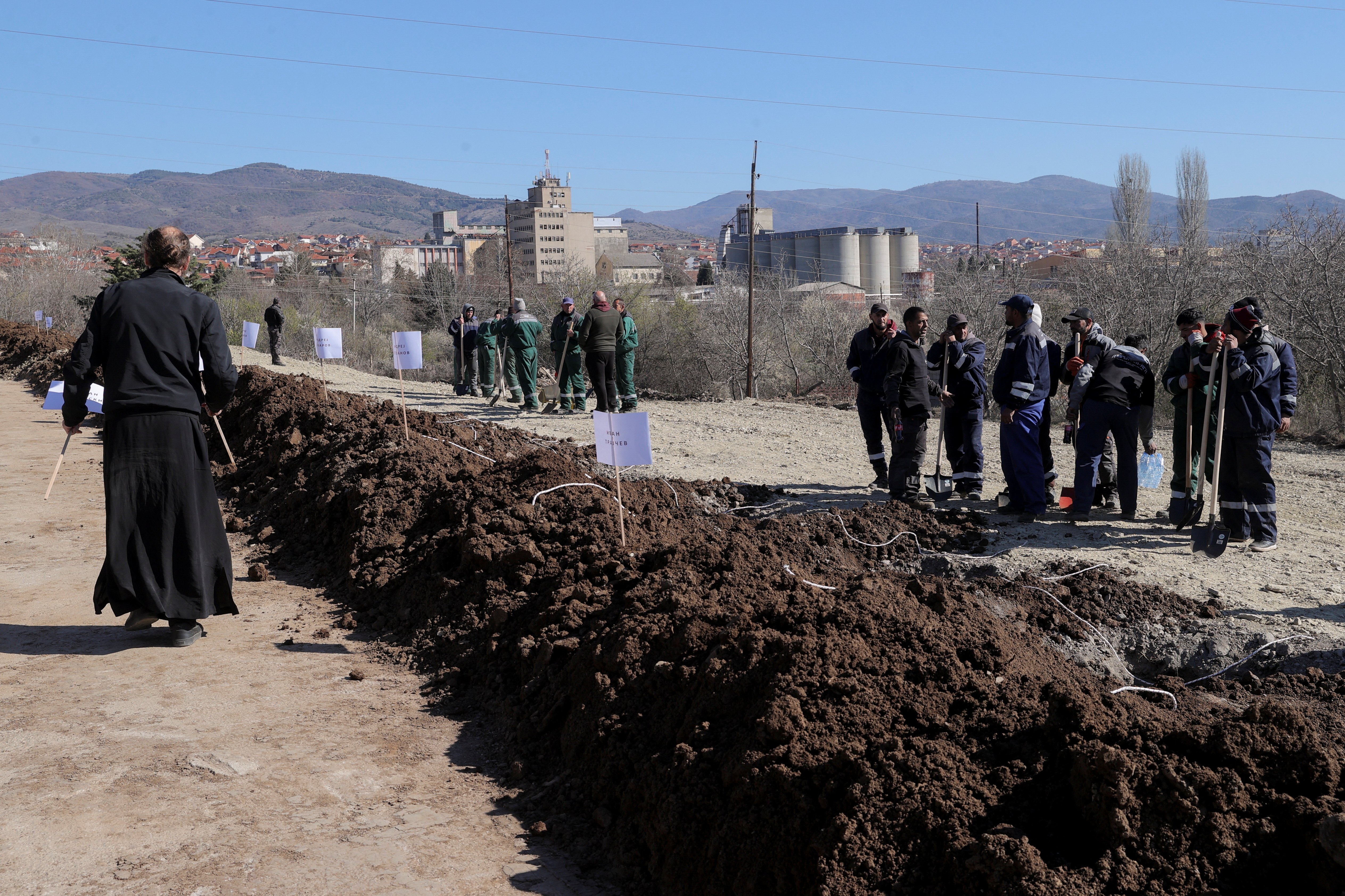Workers prepare graves for a funeral ceremony at a cemetery, following a fire at Pulse nightclub that resulted in dozens of deaths, in the town of Kocani, North Macedonia, March 20, 2025. REUTERS/Valdrin Xhemaj