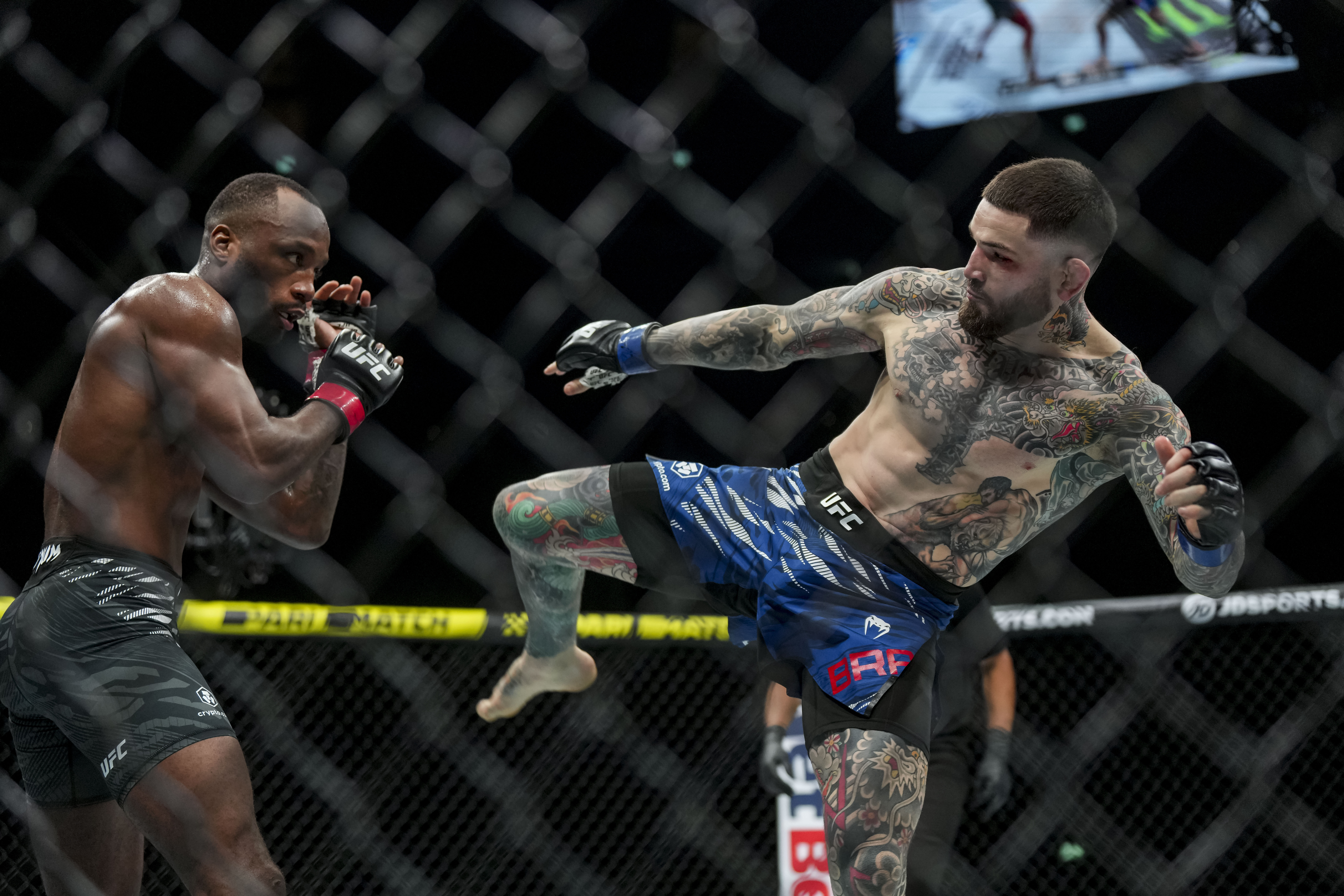 Mar 22, 2025; London, England, United Kingdom; Leon Edwards (red gloves) fights against Sean Brady (blue gloves) during UFC Fight Night at O2 Arena. Mandatory Credit: Peter van den Berg-Imagn Images