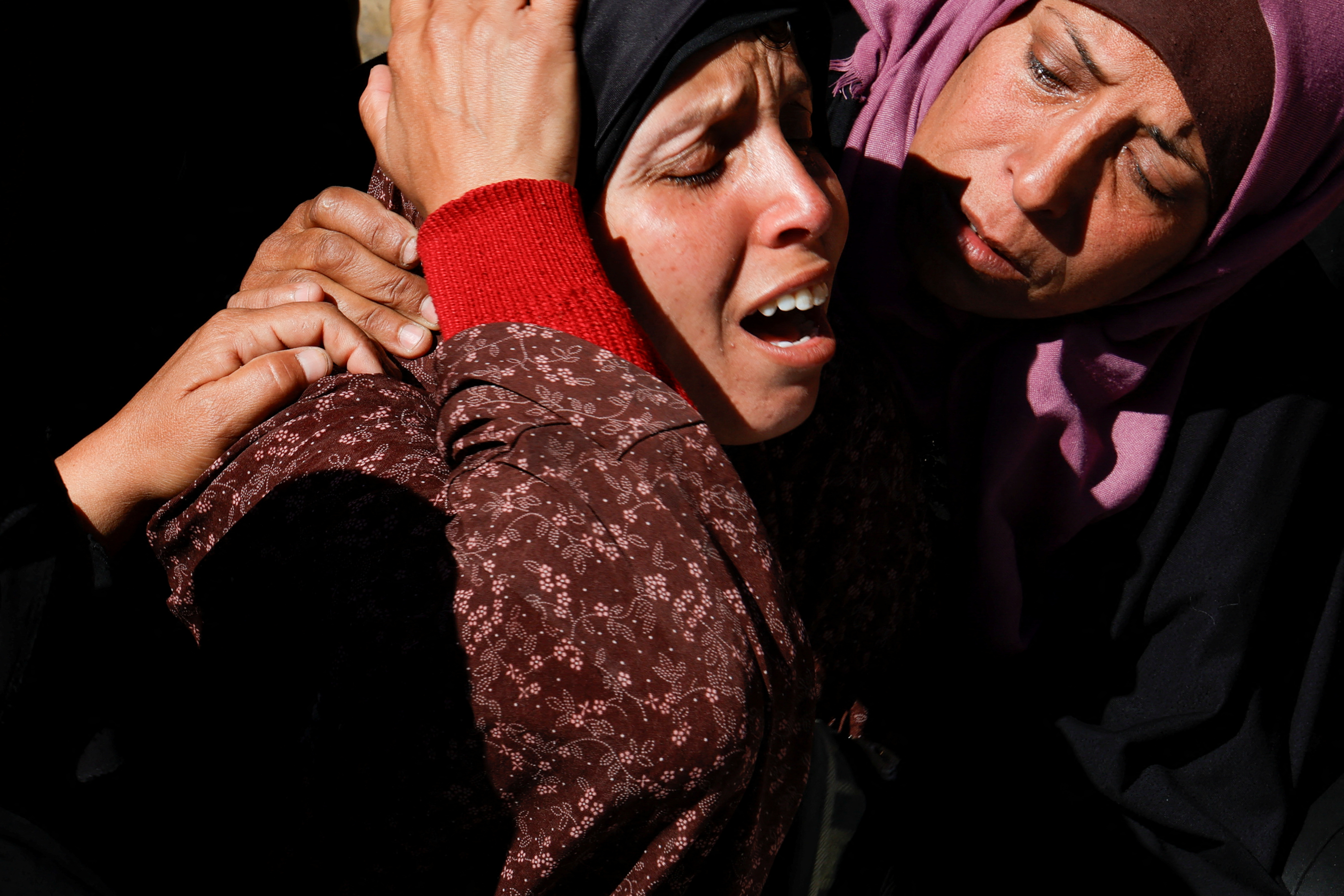 Women mourn Palestinians killed in Israeli attacks.