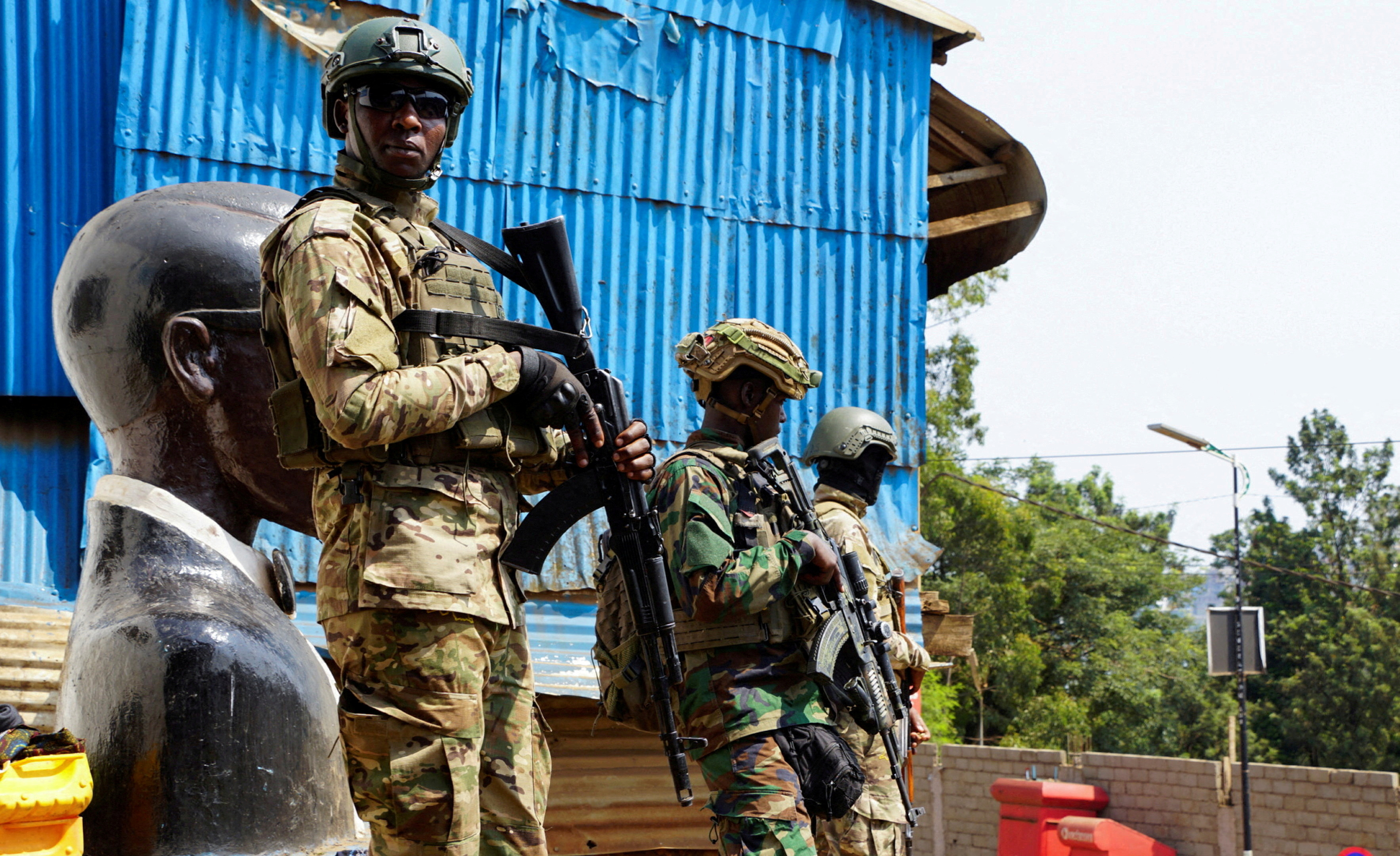Members of the M23 rebel group stand guard as people attend a rally addressed by Corneille Nangaa, Congolese rebel leader and coordinator of the AFC-M23 movement. [File: Reuters]
