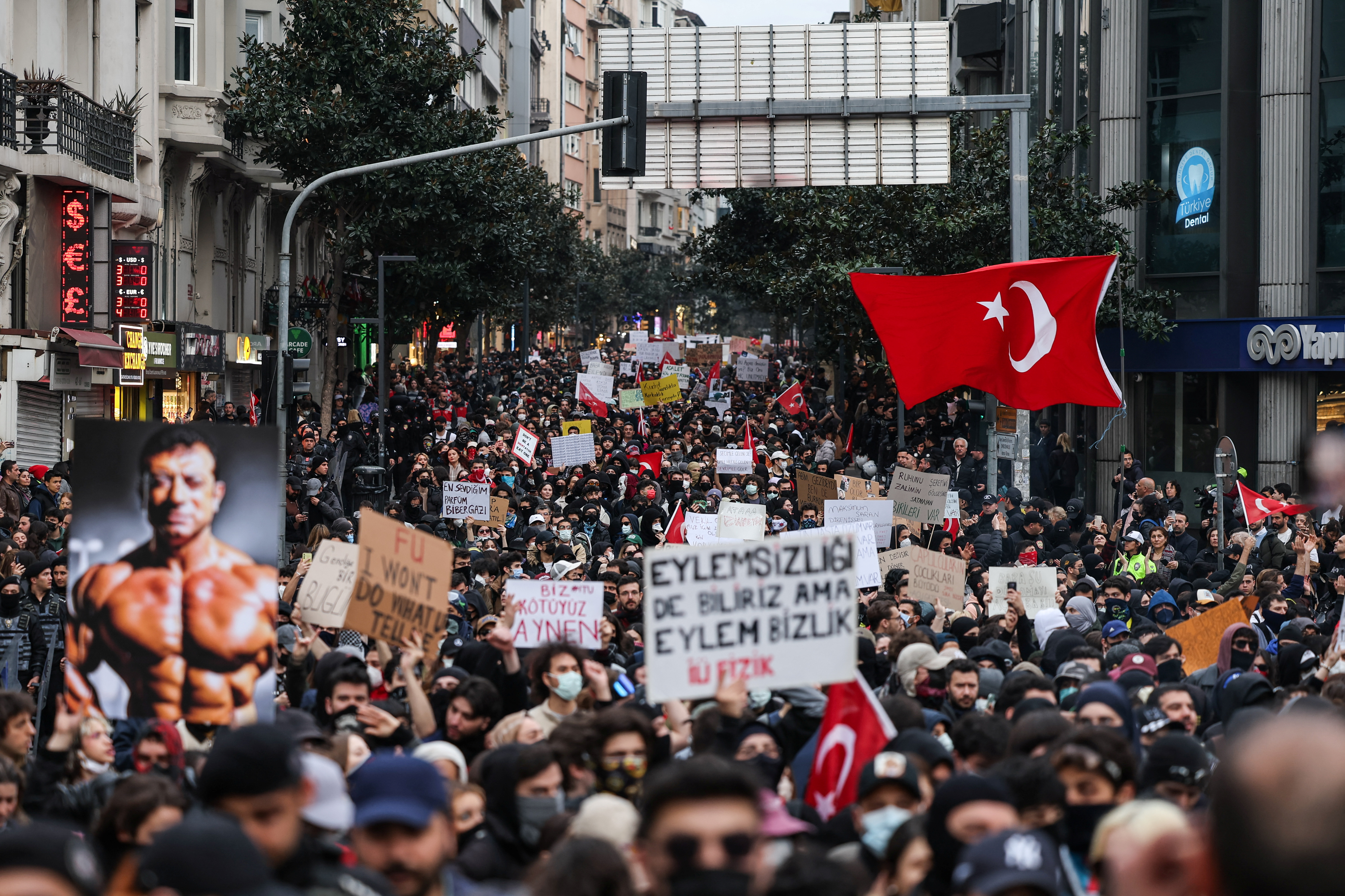 A person carries an image depicting Istanbul Mayor Ekrem Imamoglu, as people take part in a protest against the arrest of Imamoglu as part of a corruption investigation, in Istanbul, Turkey, March 25, 2025. [Umit Bektas/Reuters]