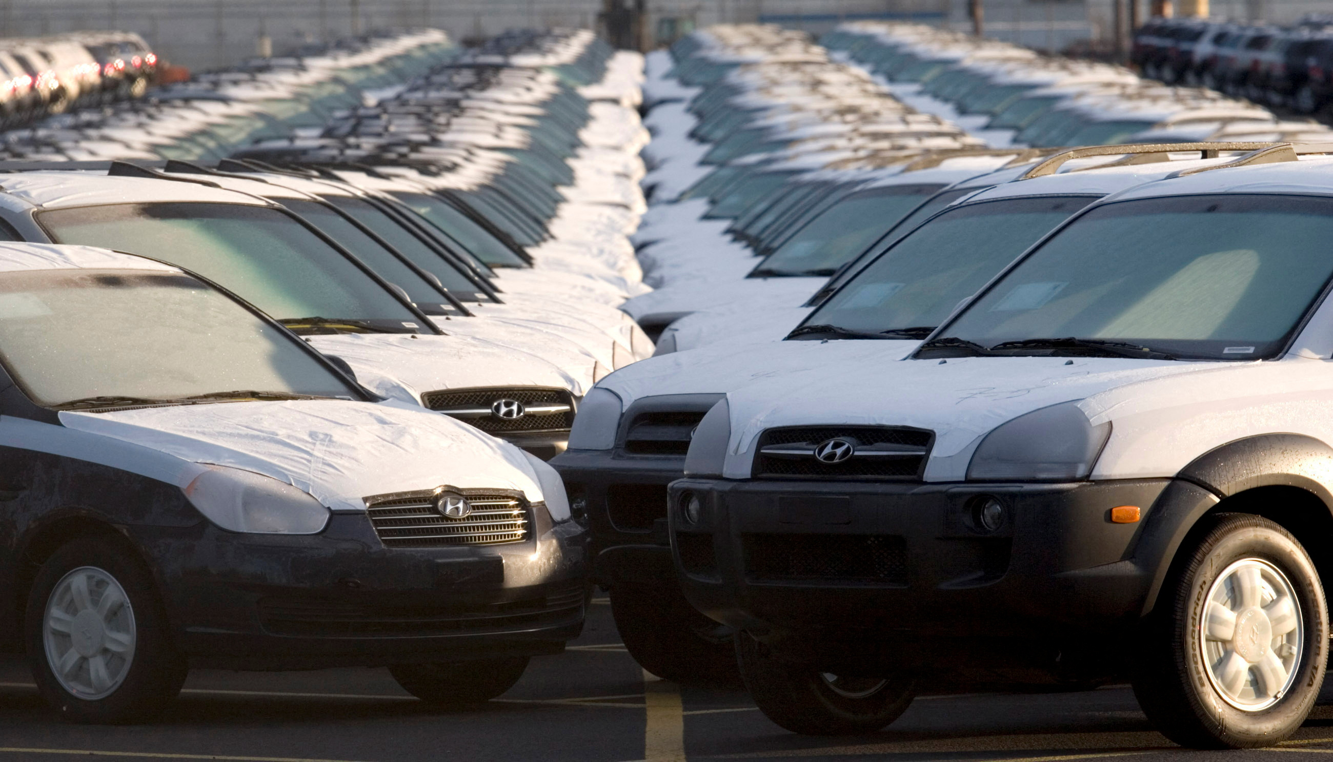 Imported cars line a parking lot in the US